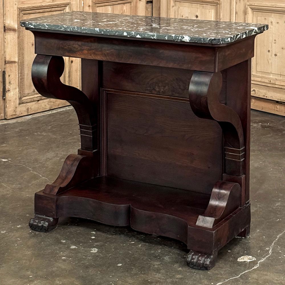 19th Century French Louis Philippe Period Mahogany Marble Top Console represents the pinnacle of the form, with the sheer natural beauty of the exotic imported wood taking center stage in the tailored design.  Gracefully scrolled legs lead down to a