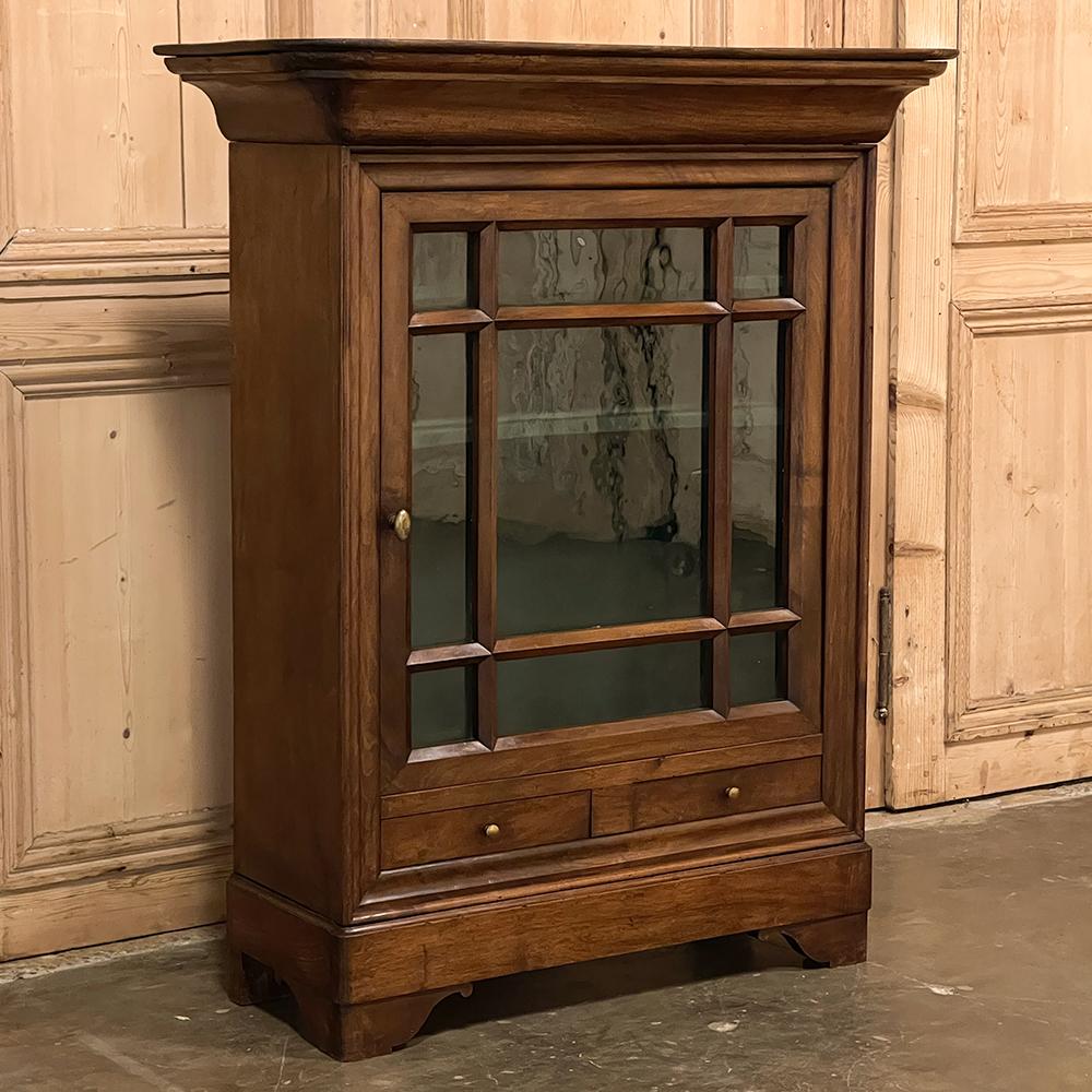 19th century French Louis Philippe Period Vitrine ~ Confiturier was designed to showcase a particularly cherished collection or family memorabilia. Hand-crafted from dense, old growth indigenous oak, it features the Classic bold crown molding of the