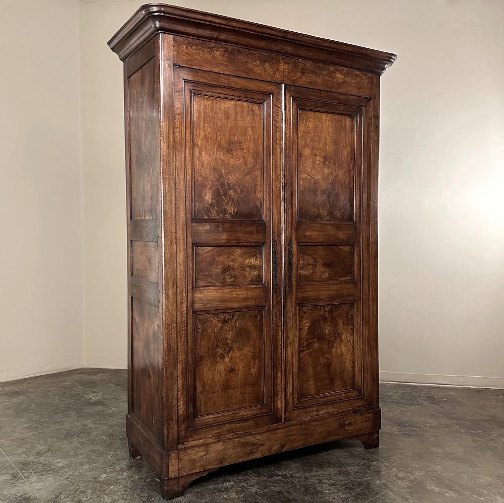 19th Century French Louis Philippe Period Walnut Armoire is a definitive example of the era, when stately, restrained architecture and furniture design rose to prominence.  Perhaps to compensate for a lack of carved or mounted detail, the artisans