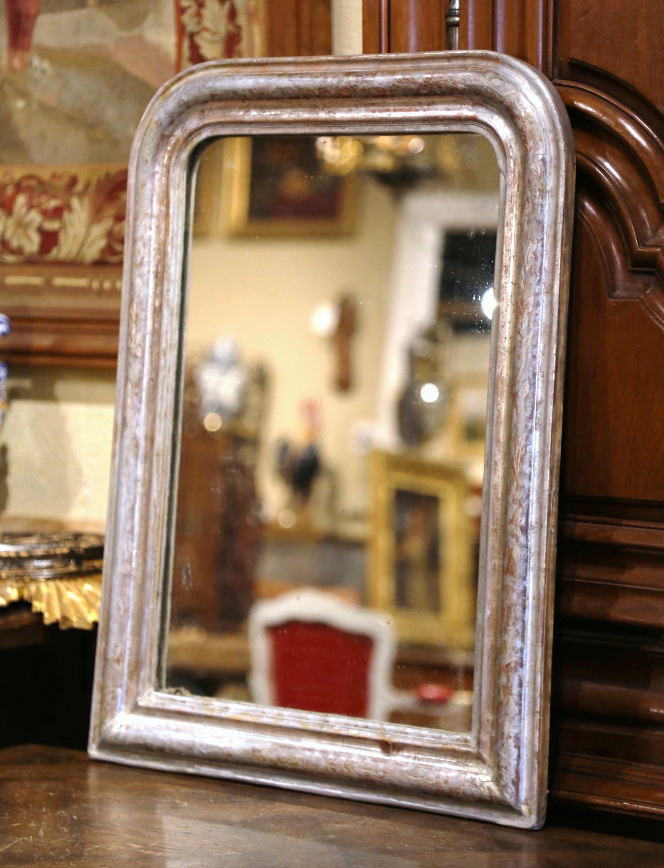 Decorate a powder room or bedroom with this elegant antique mirror. Crafted in the Burgundy region of France, circa 1870, the rectangular mirror has traditional, timeless lines with rounded corners. The frame is decorated with a patinated silver