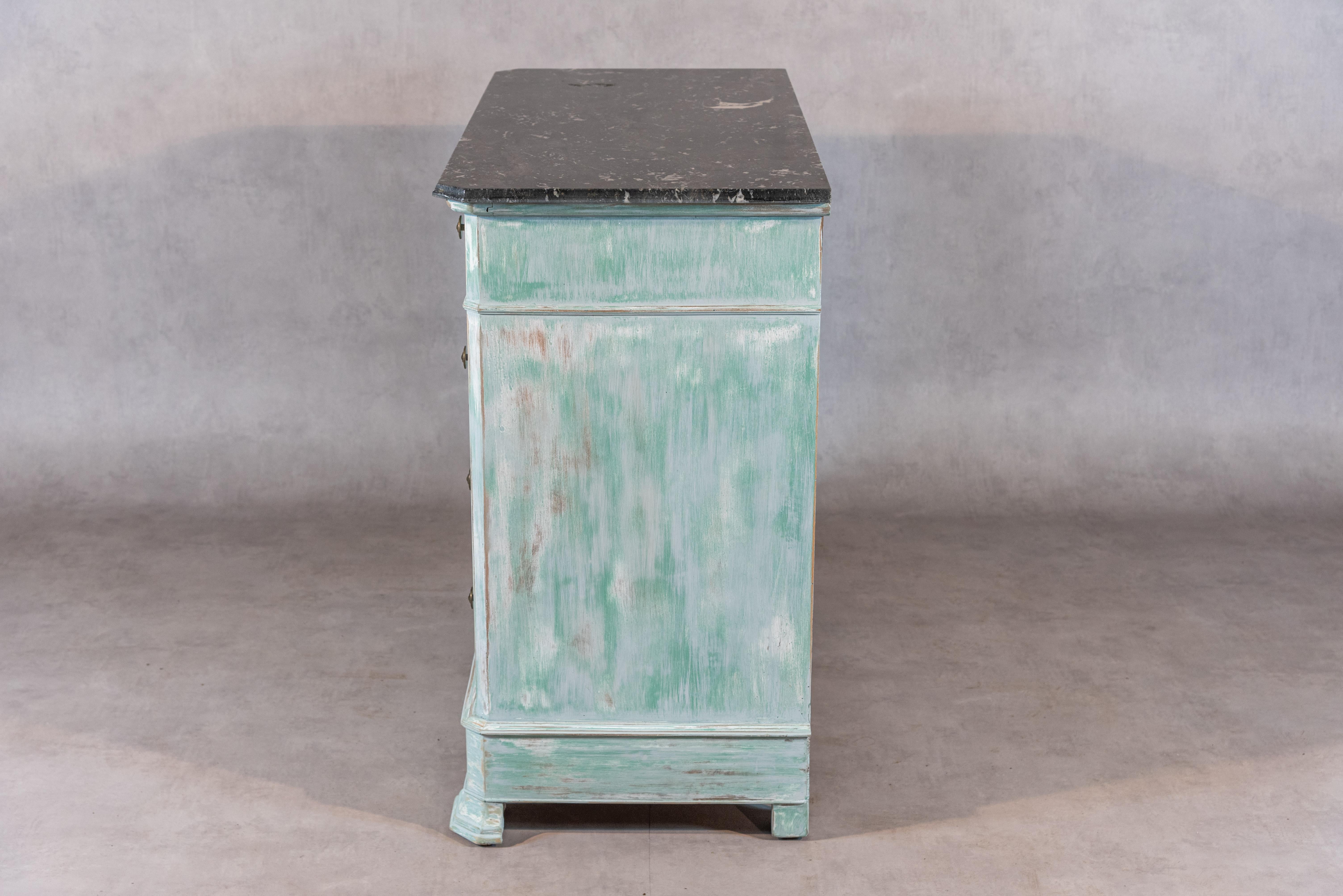 This beautiful 19th Century French Louis Philippe style commode features an impressive St Anne marble top with doucine corners and four drawers. This commode was bleached and repainted in a Fine light turquoise patina giving it a fresh and authentic