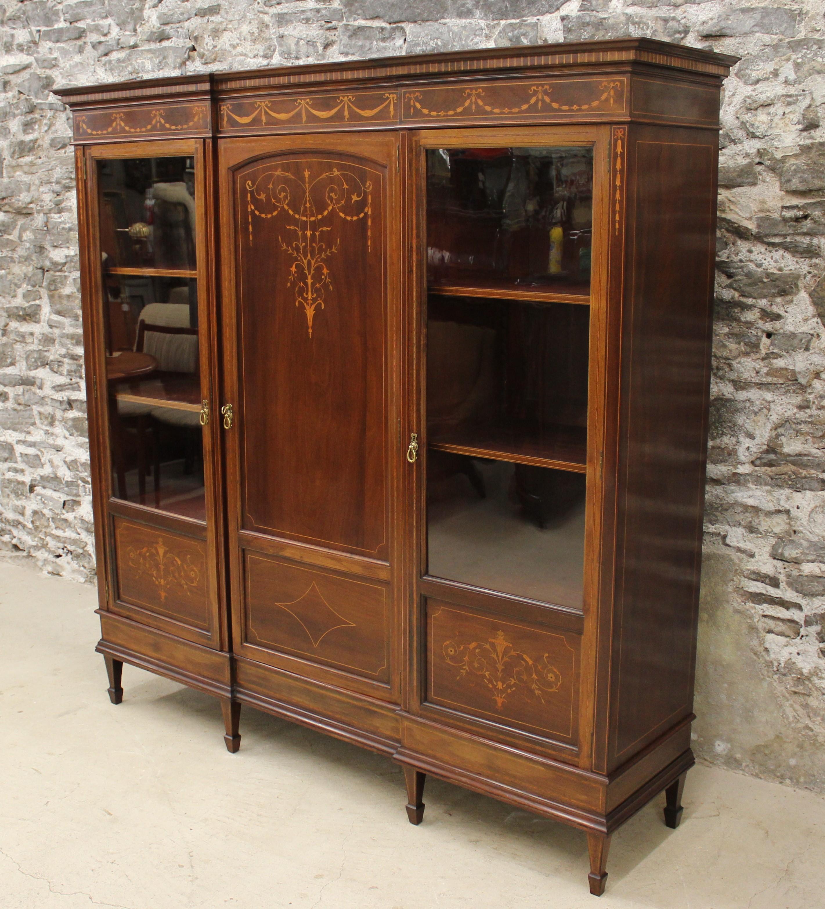 19th century French Louis XVl style blond walnut library armoire or linen press with marquetry inlay designs throughout.