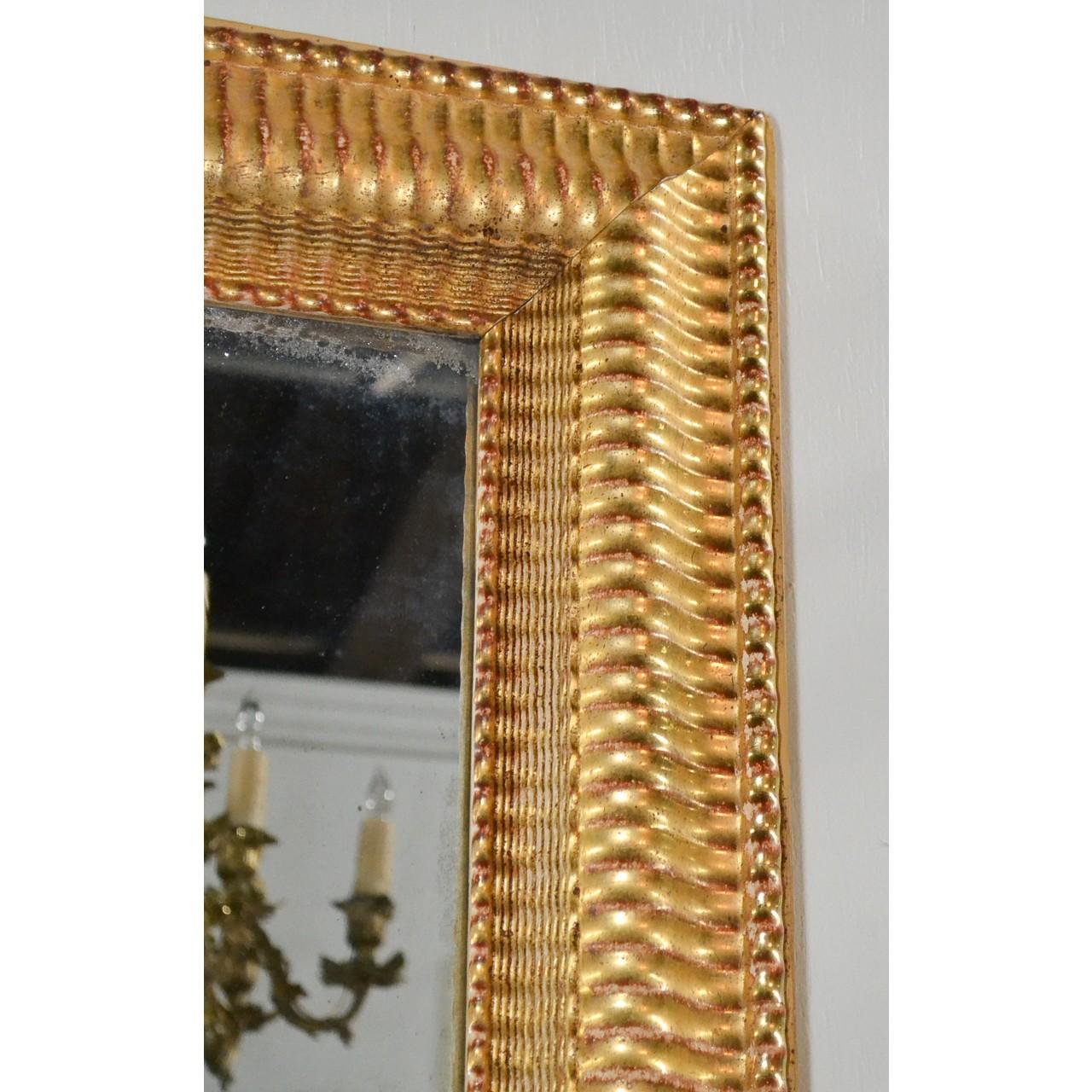 Unusual antique gilt wood Louis Philippe transitional mirror made in France,
circa 1880. Perfect for many styles of decor.
Measures: 32.5 inches wide x 56 inches height x 2.5 inches deep.
 