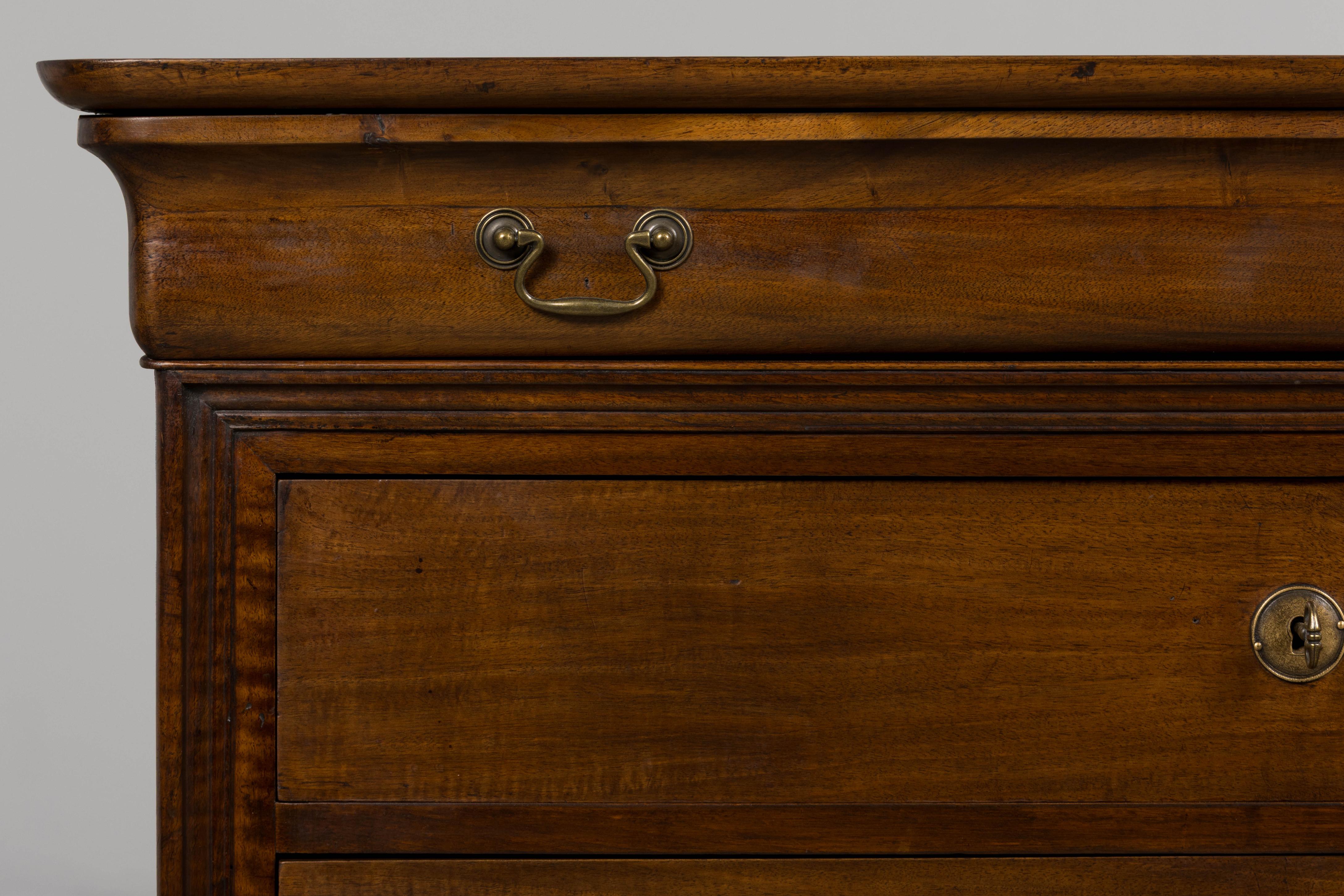 An elegant mid-19th century French Louis Philippe commode, sourced in Provence, France. Hand-crafted from solid walnut, the piece has been structurally revised and fully refinished. The surface shows a rich brown tone with striking grain, subtle