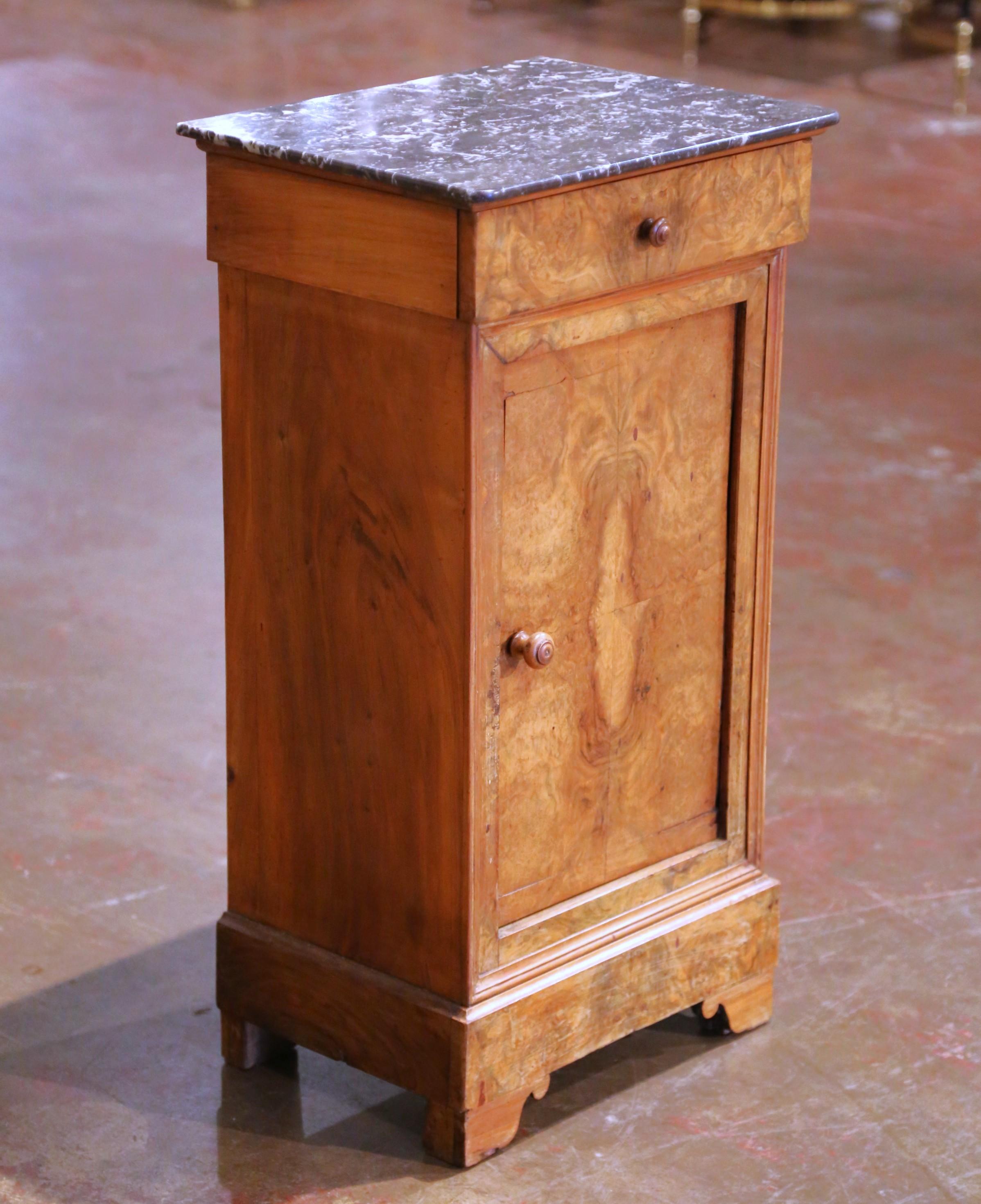 Crafted in France circa 1890, this refined walnut nightstand is a handsome example of the Louis Philippe period. The compact cabinet stands on shaped bracket feet over a molded plinth base and features a single drawer above a paneled door fitted