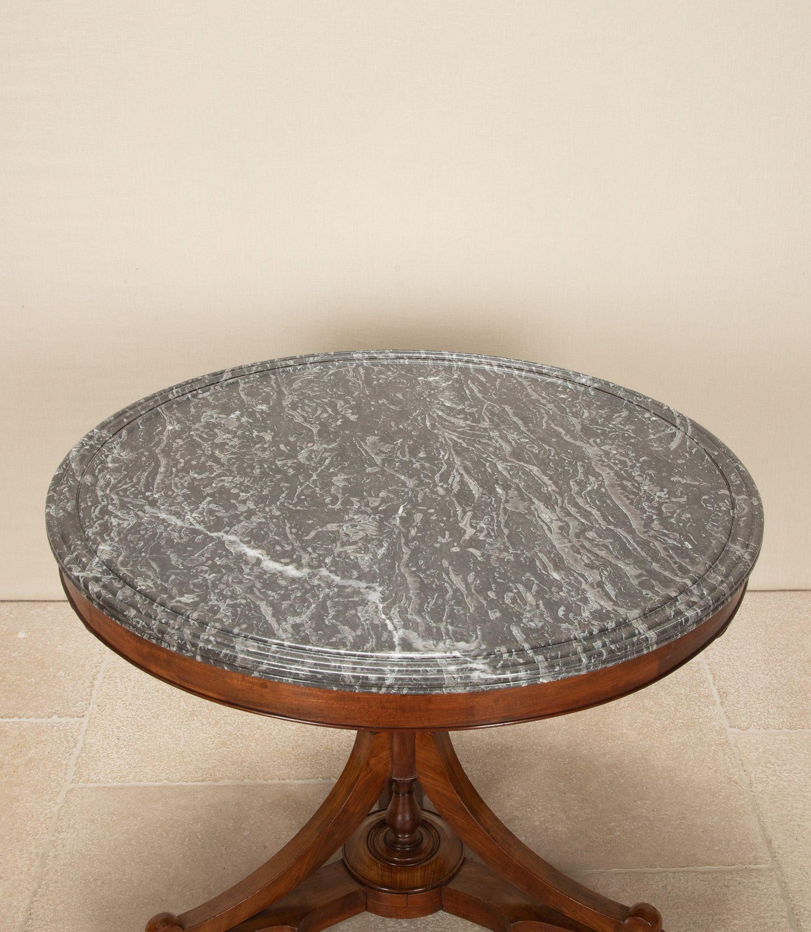 An unusual 19th Century French Louis Philippe mahogany gueridon.
With an attractive X frame base and dark grey veined intricately dished marble.