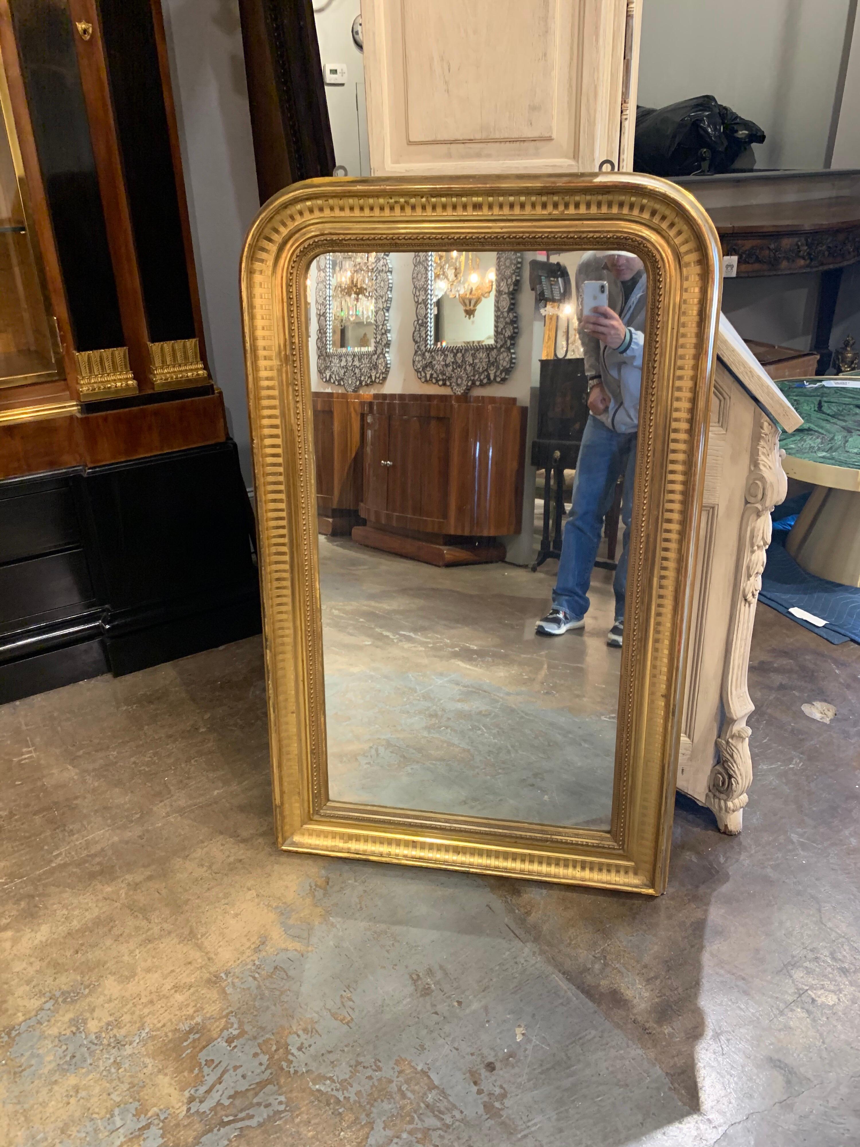 Beautiful Louis Phillipe mirror with gold gilt finish. The piece has a line pattern and beaded detail. Very elegant!