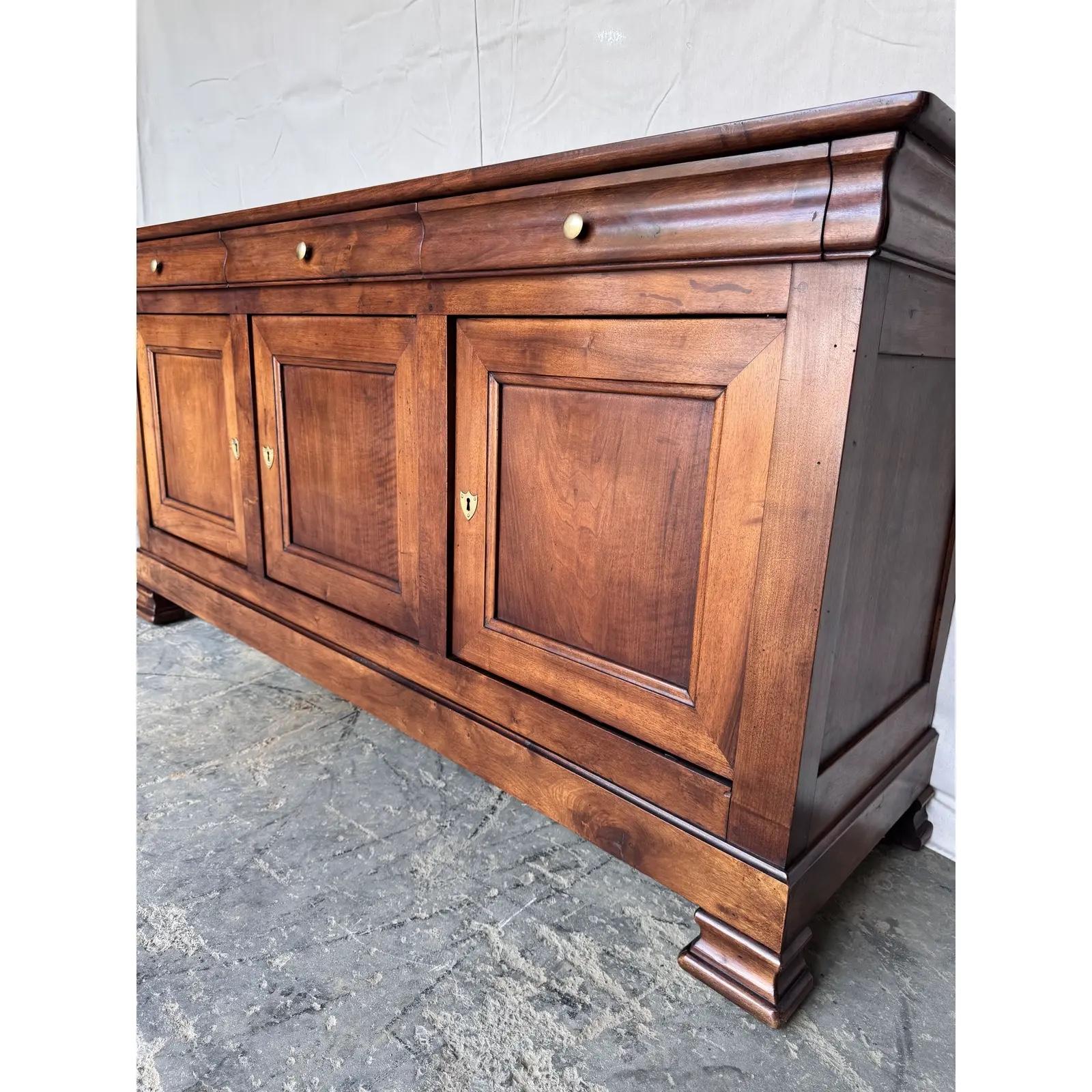 This 19th-century Louis Philippe French server exudes timeless elegance with its ornate craftsmanship and rich walnut finish. This is one the cleanest pieces i'v ever had with the doors and drawers working perfectly. A perfect blend of functionality
