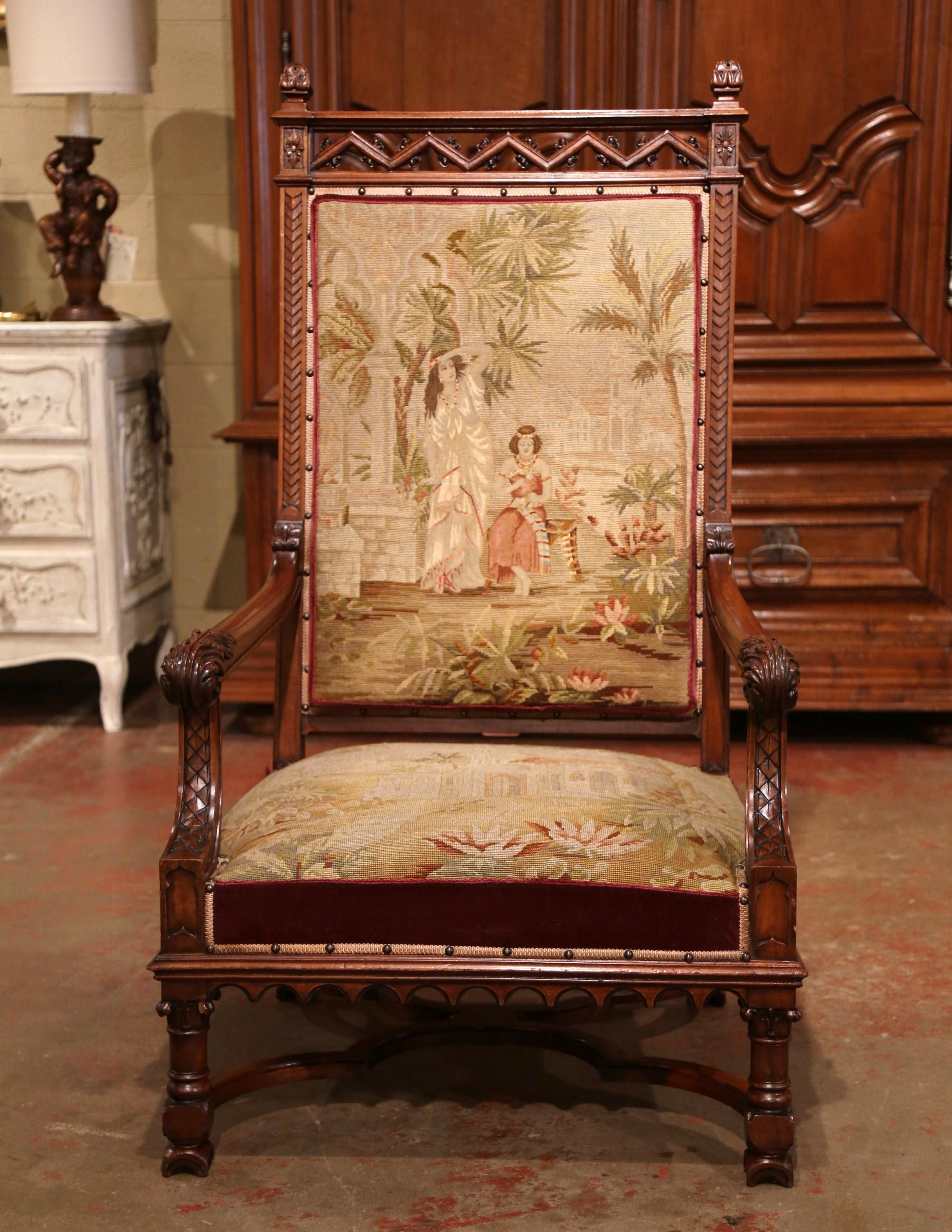 Decorate an office or a study with this large antique fruitwood king armchair, crafted in Southern France circa 1860, the important chair is upholstered with the original needlepoint tapestry, embellished with decorative nailheads. It features a