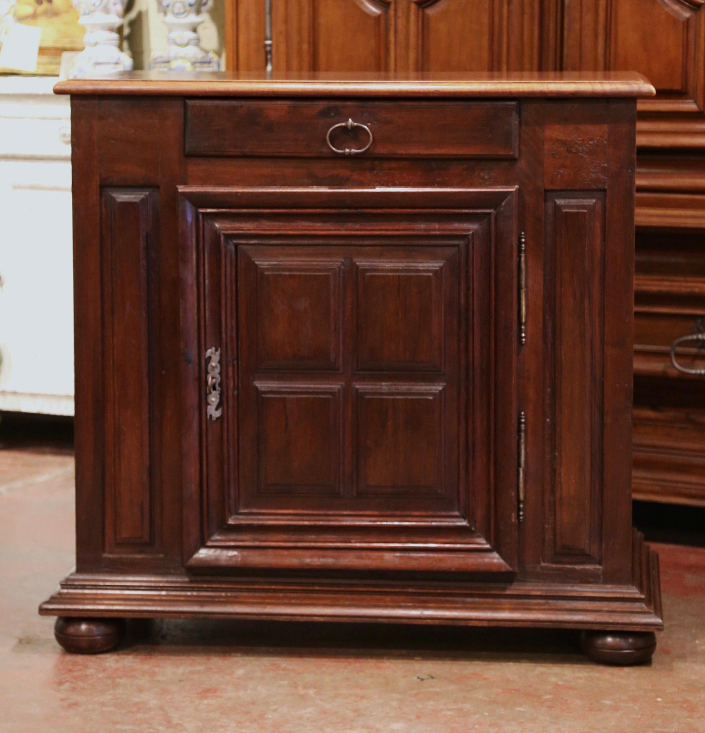 This elegant antique jelly cabinet was crafted in southern France, circa 1880. Standing on bun feet over a molded plinth base, the provincial confiturier is fitted with a single drawer with iron pull over a raised paneled center door. The inside has