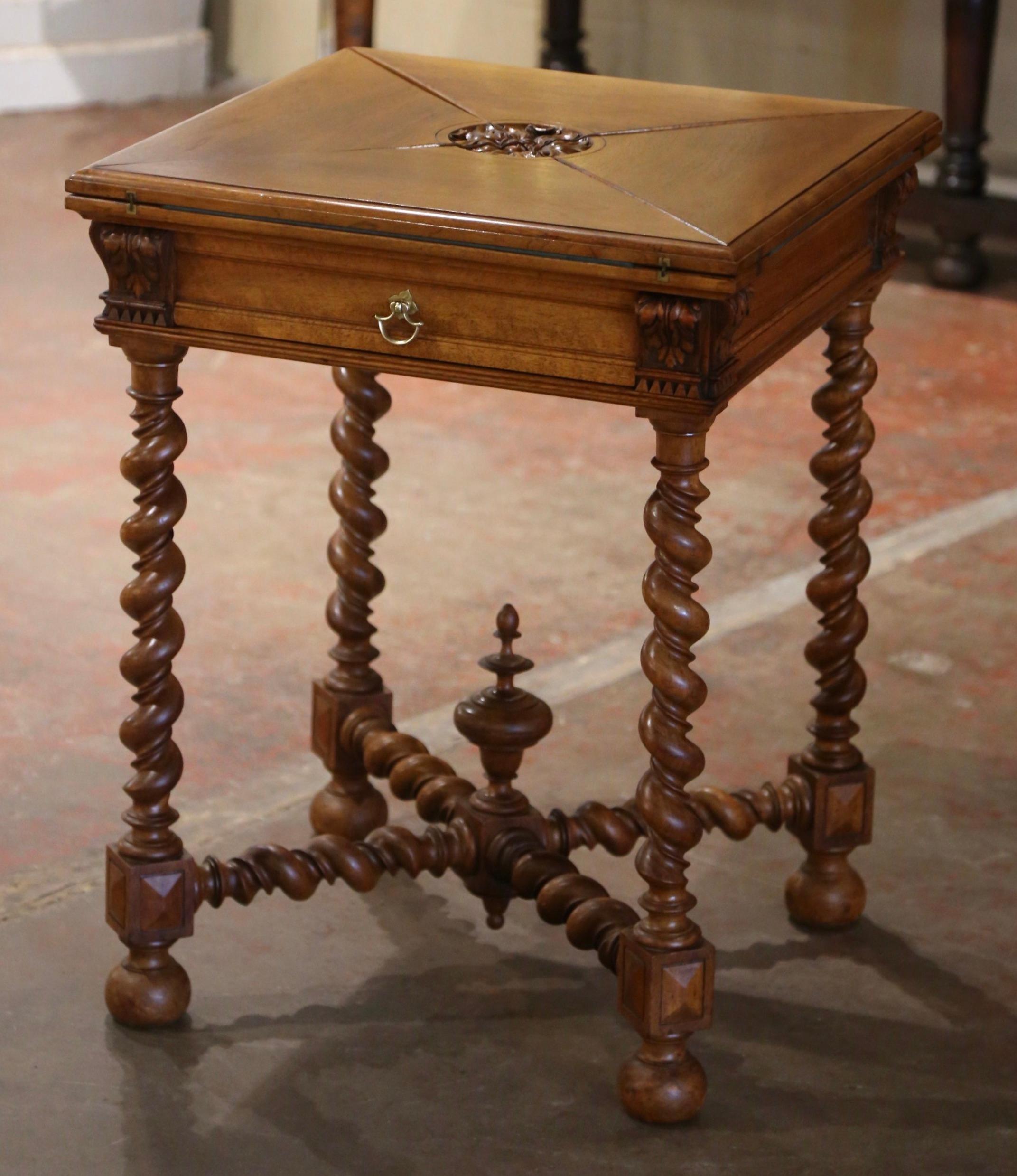 Decorate a game room or a den with this elegant antique folding card table. Crafted in France circa 1890 and built of walnut wood, the square table stands on barley twist legs ending with bun feet, connected with a X-form cross stretcher at the base