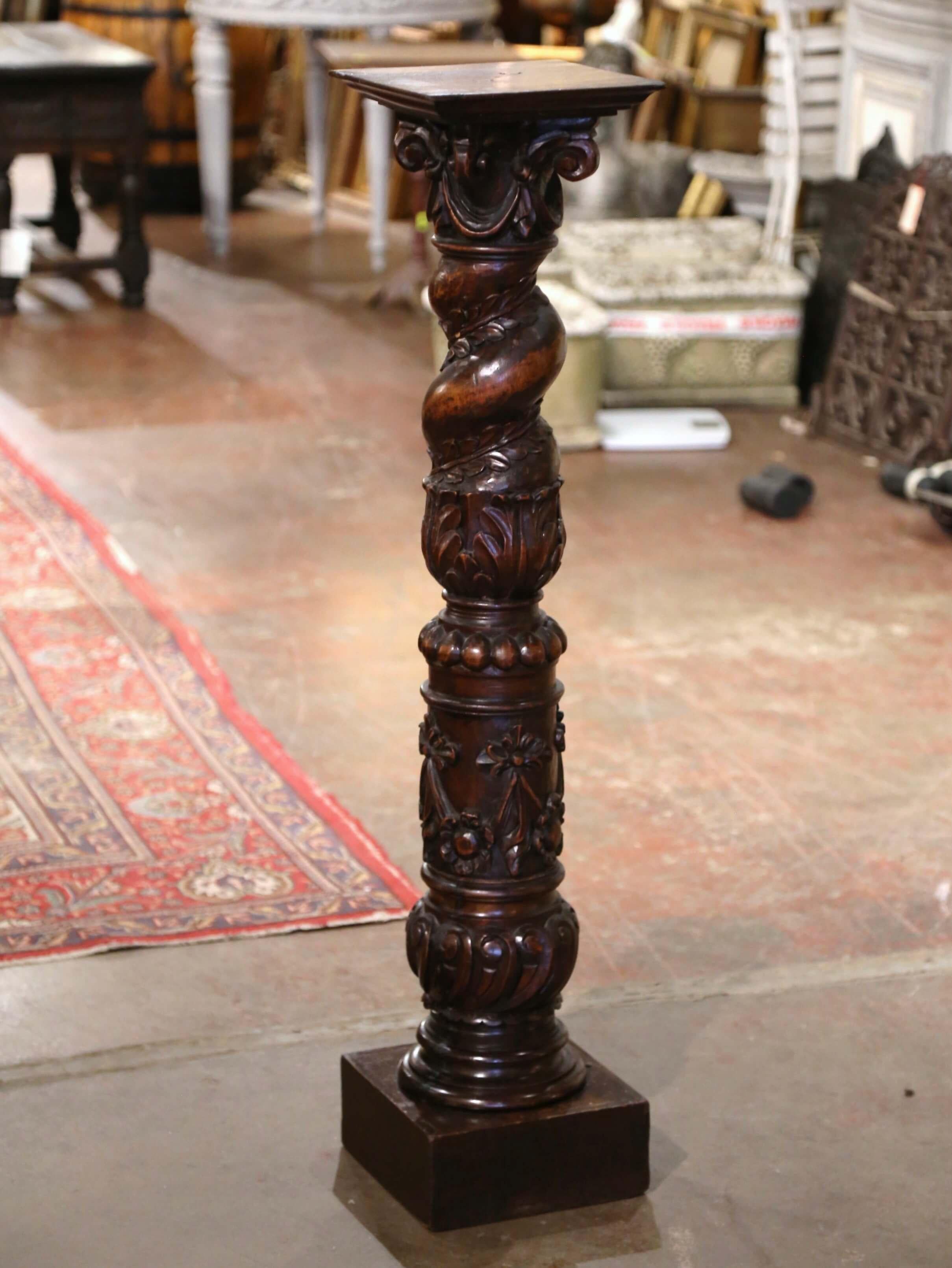 Dieser elegante antike Sockel wurde um 1870 in der Region Burgund in Frankreich hergestellt. Die hohe Säule aus Nussbaumholz steht auf einem quadratischen Sockel über einem kreisrunden, gedrechselten Schaft, der mit handgeschnitzten Lorbeerblättern,