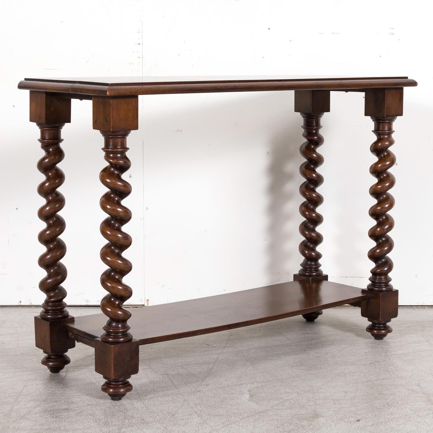A fantastic 19th century French Louis XIII style petite barley twist console table hand crafted of solid walnut in Bordeaux, circa 1890s. Having a rectangular beveled plank top resting on four beautifully hand carved and turned barley twist legs