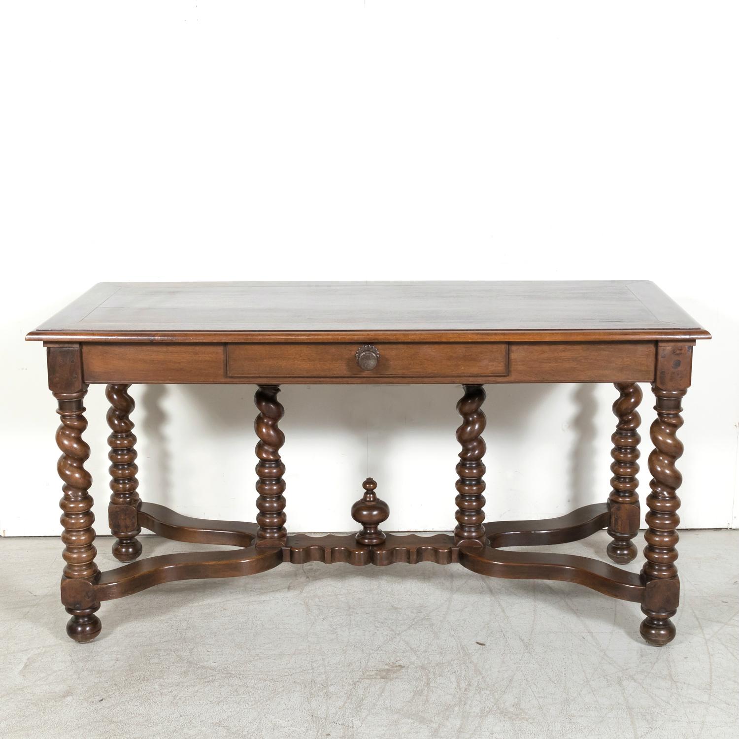 A handsome 19th-century French Louis XIII style barley twist console table, circa 1870s, meticulously handcrafted from walnut in the esteemed port city of Bordeaux, renowned for its illustrious wine growing heritage. Reflecting the opulence of King