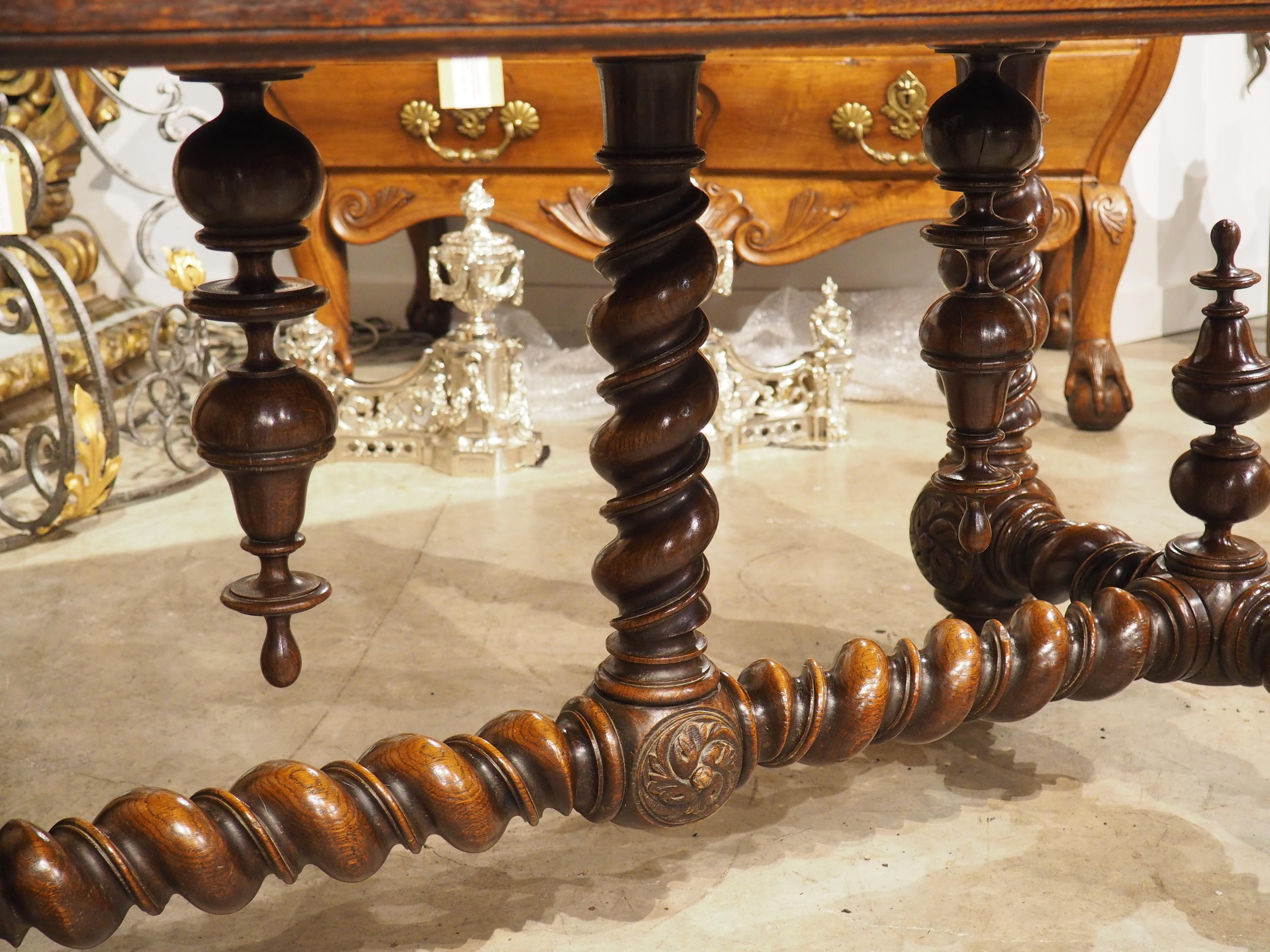 A hallmark of Louis XIII-style furniture is highly turned wood, as evidenced by the legs of this amazing French writing table. Hand-carved in oak during the 1800s, the dark brown patina of the base accentuates the wonderful carvings.

The roughly