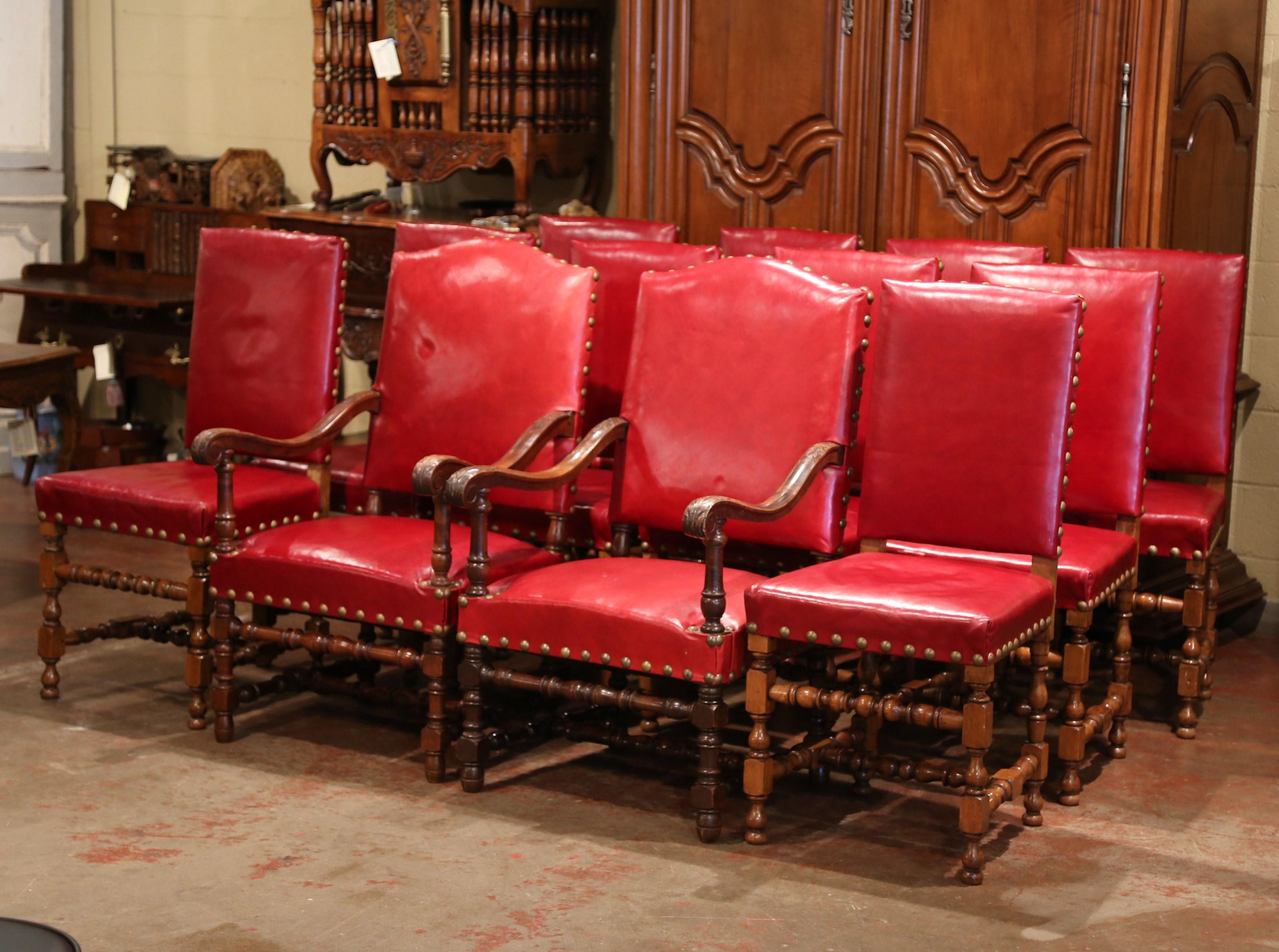 Dress your dining room table with this antique suite of ten side chairs and two matching armchairs. Crafted in France, circa 1870, each fruitwood chair sits on carved turned legs; each tall back and wide seat are upholstered with the original red