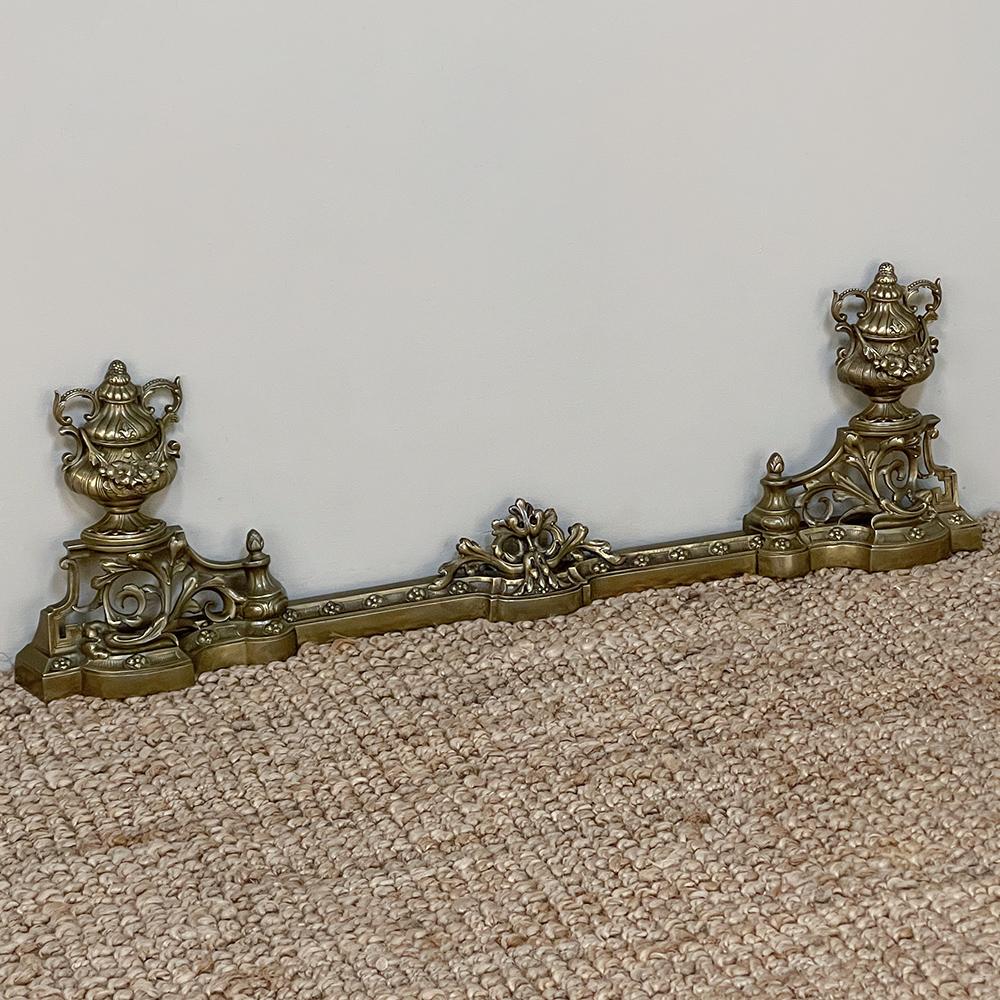 19th Century French Louis XIV bronze fireplace fender set is the perfect way to put a finishing touch on your decor! Cast in solid bronze, it features motifs of two urns on pedestals to front your andirons, and a fender that joins the two that fits