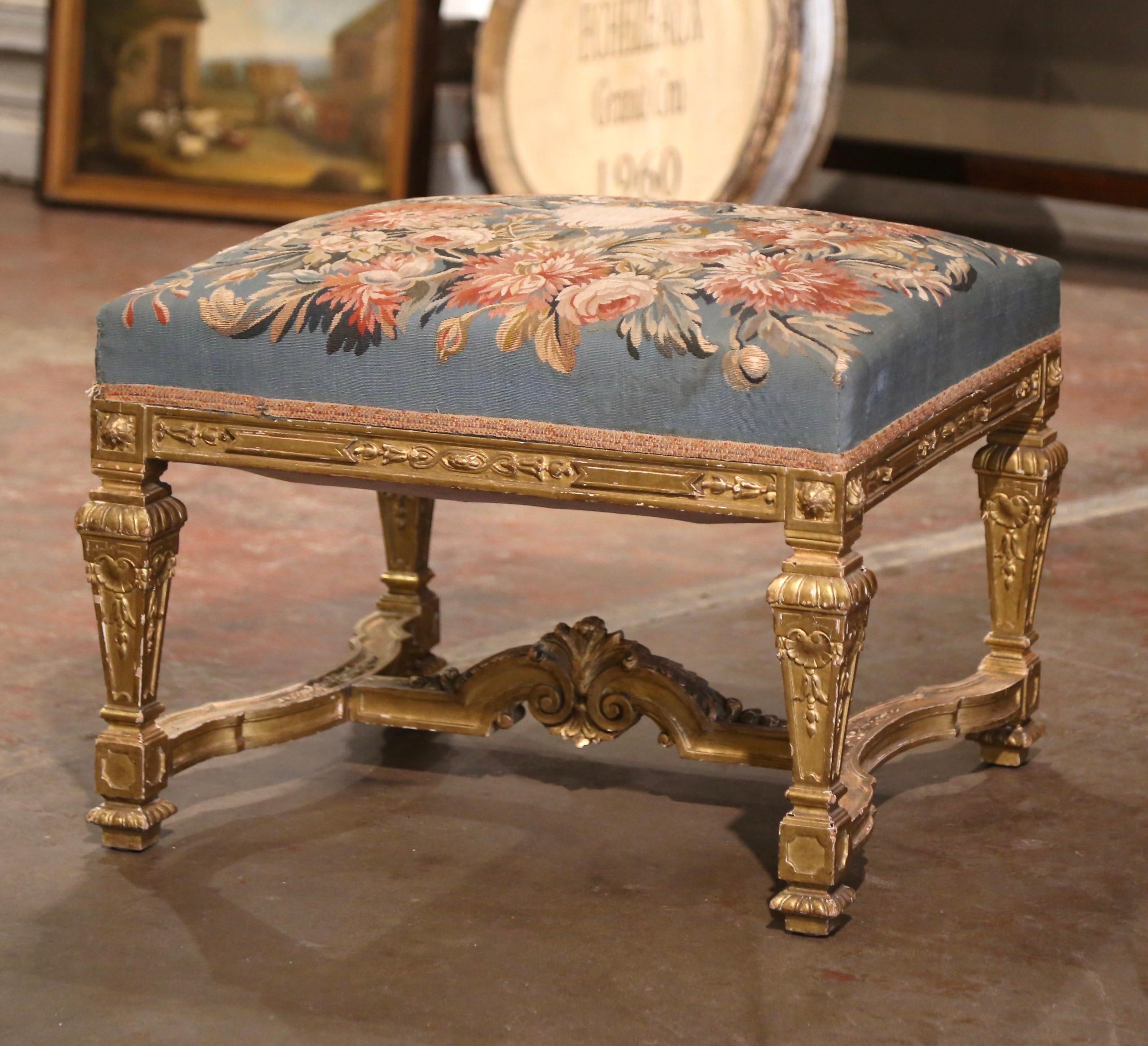 Decorate a den, living room or master bedroom with this elegant antique stool. Crafted in Versailles France circa 1870 and rectangular in shape, the elegant ottoman stands on tapered legs decorated with hand carved rosette medallions at the