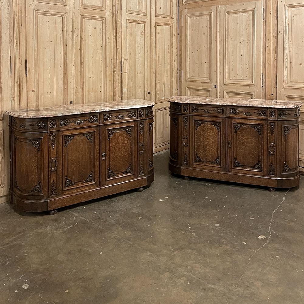 19th century French Louis XIV marble top buffet represents an elegant blend of neoclassical architecture and hand-carved embellishment inspired by the reign of the Sun King. Hand-crafted from solid oak, it features rounded sides eliminating sharp