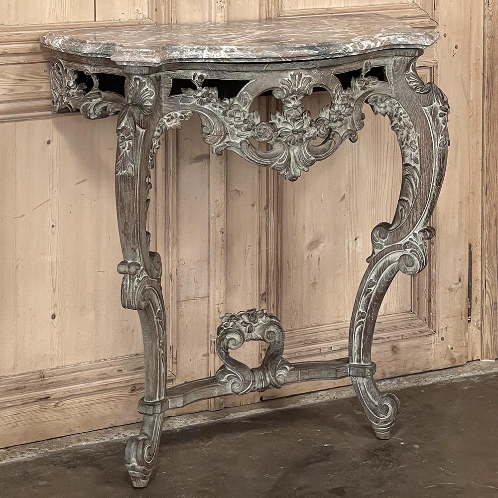 19th Century French Louis XIV Painted Marble Top Console is an ideal choice for making a visual statement with subtle style and grace!  Hand-crafted from old-growth oak, it features a curvaceous frame inspired by the Baroque movement, with the apron
