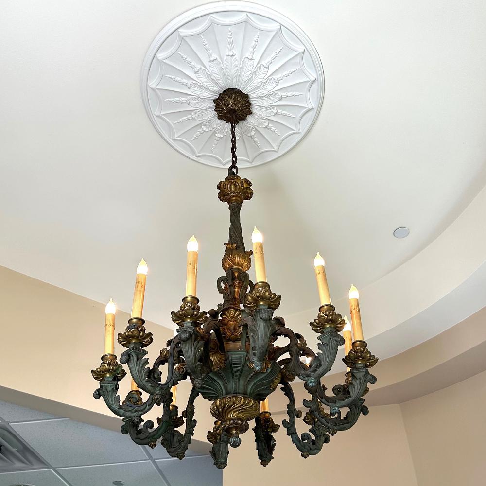 19th century French Louis XIV Patinaed Bronze & Gilt Bronze Chandelier is a master work of the Belle Epoque Period! Meticulously hand-cast in solid bronze with gilt bronze accents, it was designed for an opulent home before the days of widespread