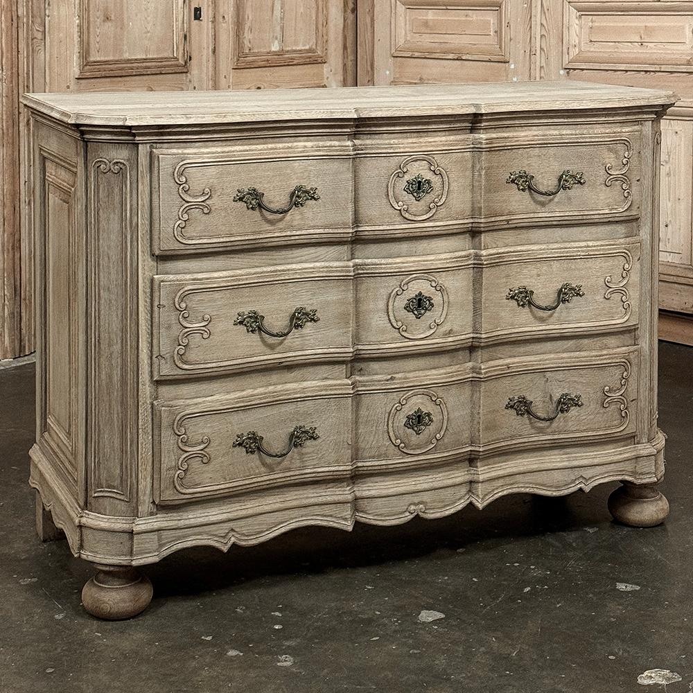19th Century French Louis XIV Stripped Oak Commode is a tailored, slightly rustic expression of the style, but made with a definitive architecture that is truly timeless.  The beveled top follows the contours of the casework below which include