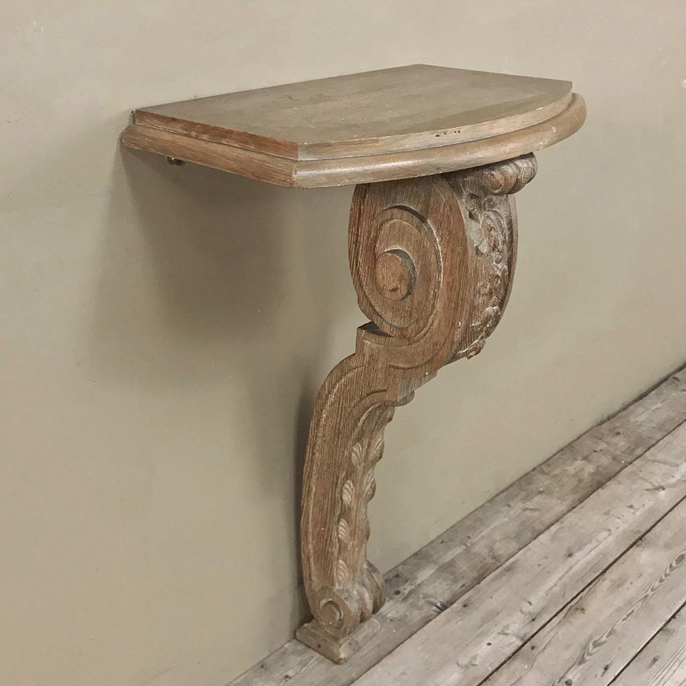 19th century French Louis XIV stripped oak console features a single elaborately scrolled and hand carved leg and a diminutive size making it perfect for that special niche or cove. Intriguing finish features a very subtle whitewash over stripped