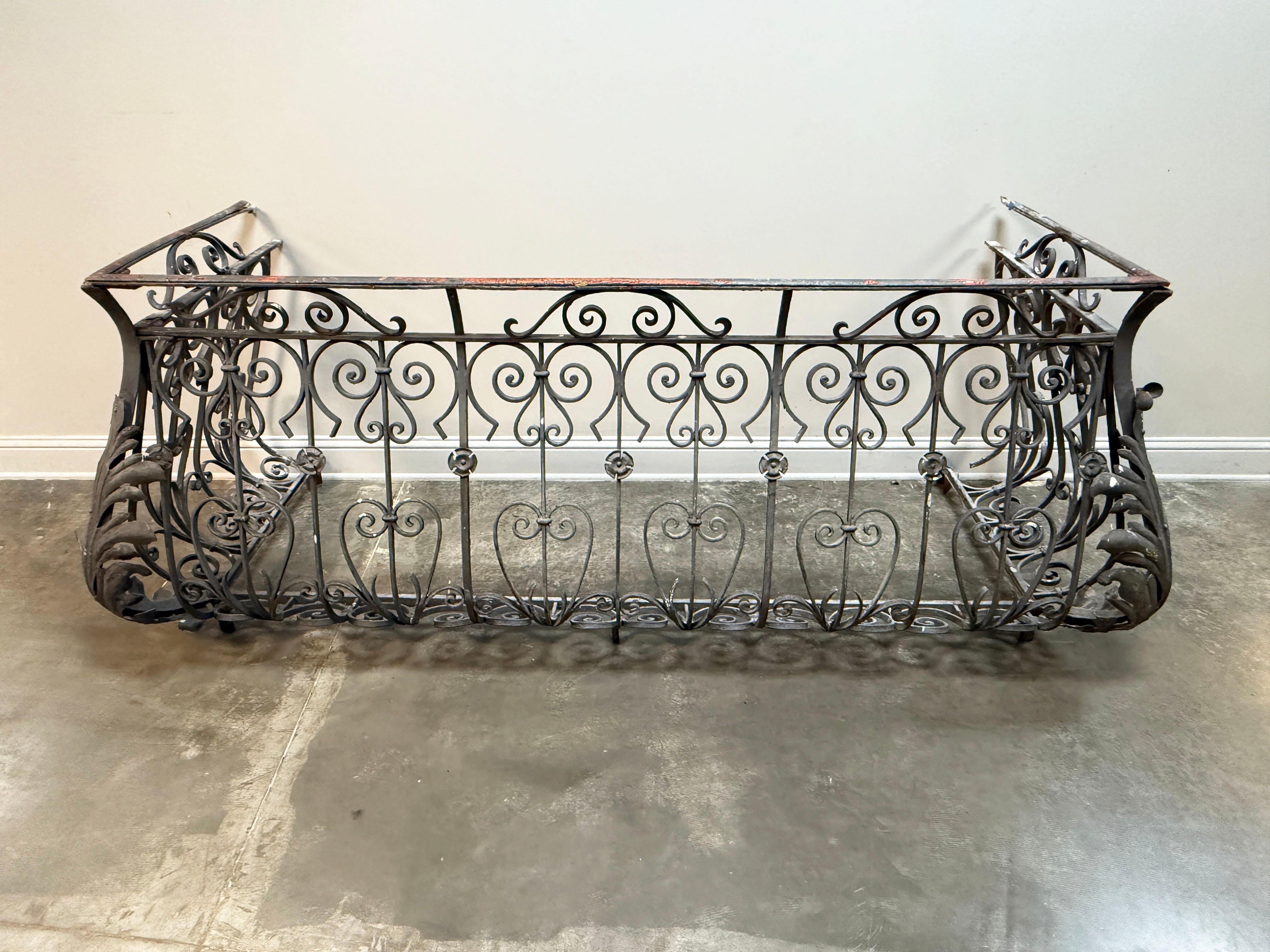 19th C. French Louis XIV wrought iron bombe balcony railing. It is characterized by its hand-forged, ornate scrollwork and a bombe form that curves outward. These types of railings were popular during the Napoleon III period and can be found on