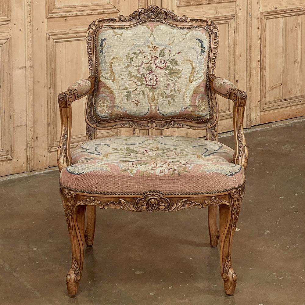 Le fauteuil en noyer Louis XIV du XIXe siècle avec tapisserie à l'aiguille est un remarquable exemple de sculpture qui s'avère également être un fauteuil confortable !  Sculpté à la main dans du noyer blond français de premier choix, il présente les