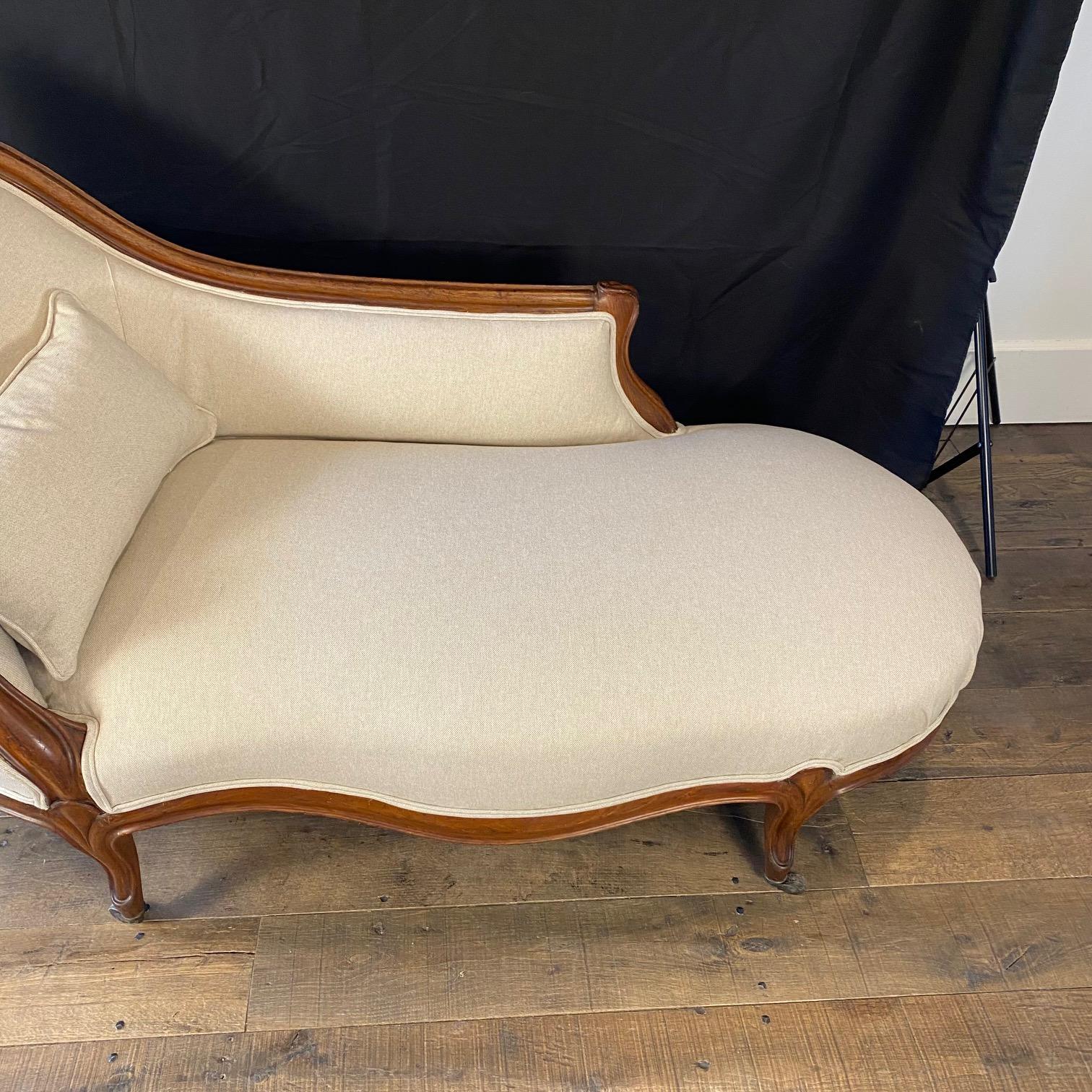 French 19th century newly upholstered lovely carved mahogany Louis XV chaise having graceful curves. #6445

H seat 17” x H arm 24.25” x W 63” x W seat 50” 
