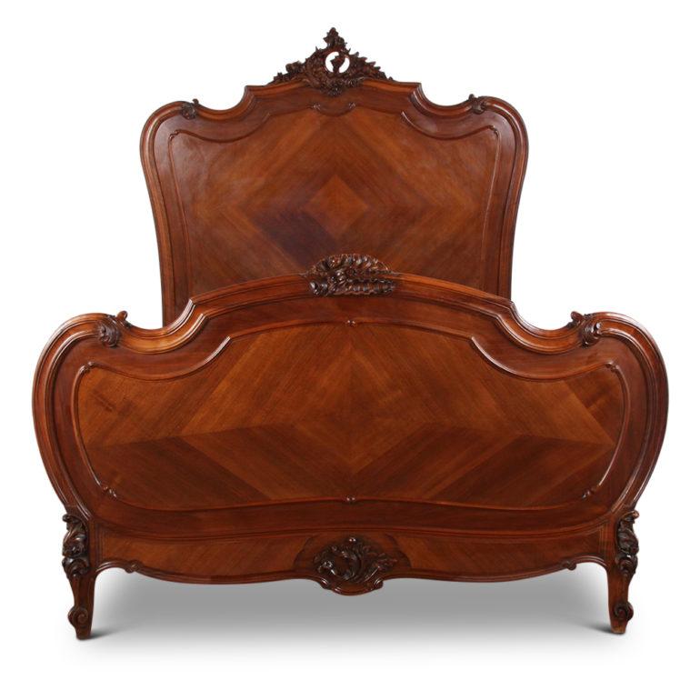 A French Louis XV-style walnut bed with highly pierce-carved crests, scrolled feet, and floral details. Beautiful hand carving on this piece, Circa 1890.

Measures: 80 inches long x 60 inches wide (overall) x 64 inches tall (headboard) x 38 inches