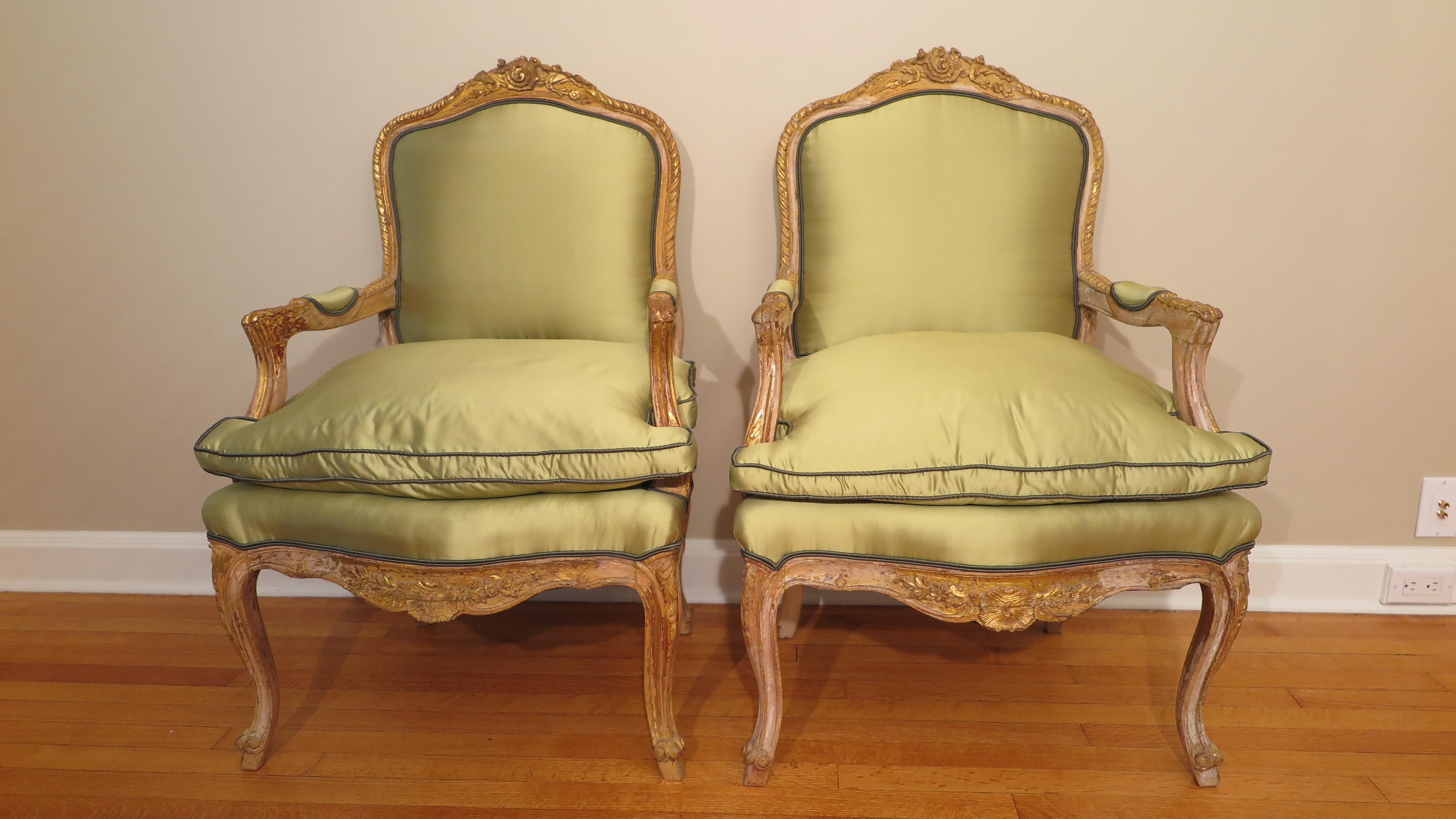 19th century French Louis XV style bergères armchairs. Very comfortable carved wood with remnants of gilding having silk covering in good condition. Beautiful addition to any room.