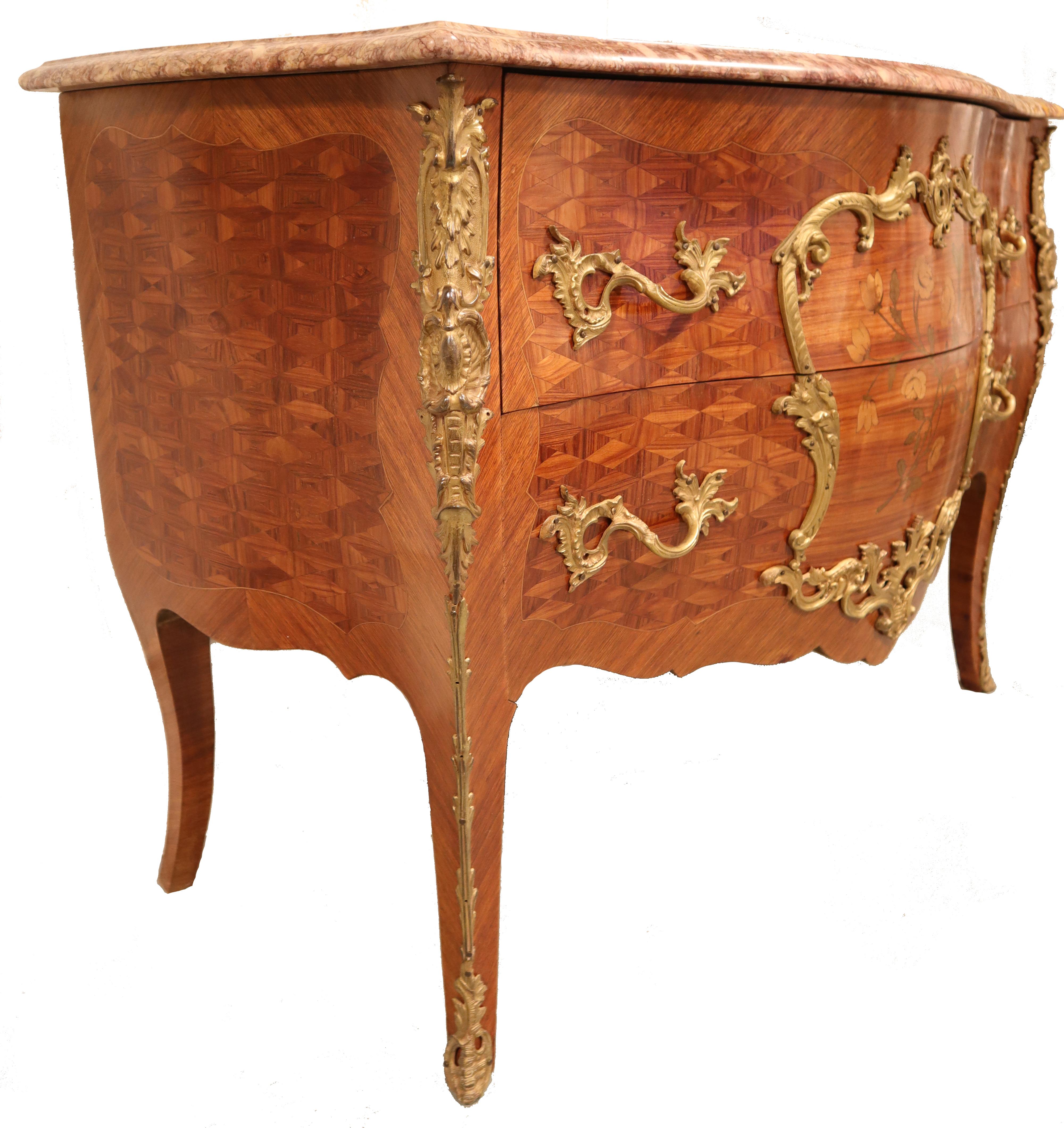 19th century French Louis XV Bombe marble top commode features exotic imported woods crafted in an exceedingly complex bombe shape, then adorned with lavish marquetry inlay, exquisite cast bronze ormolu mounts, and of course, a luxuriously veined