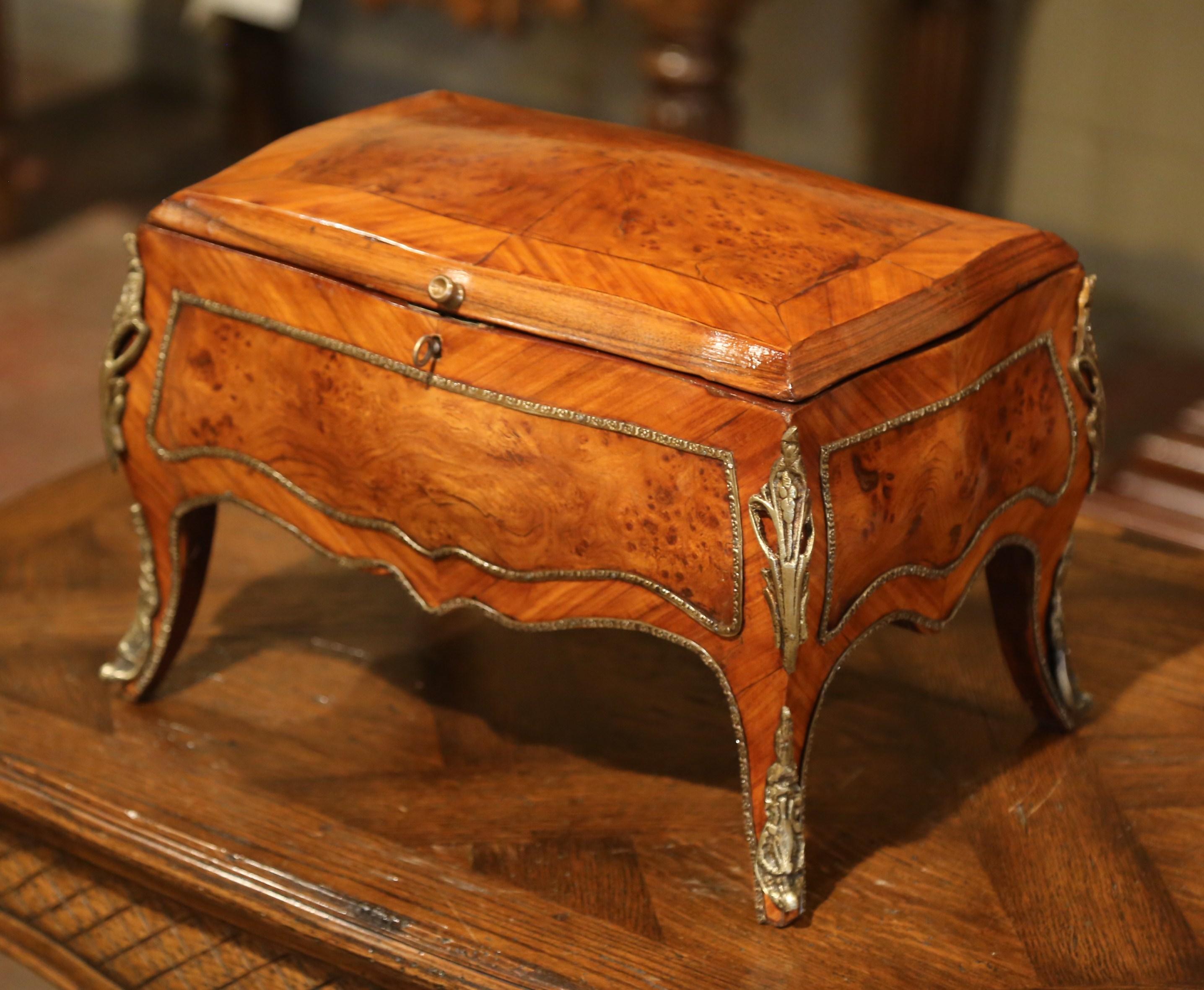 Place this elegant antique fruit wood box in your master bath to keep your jewelry safe and organized. Crafted in France circa 1850, and made of walnut and burl, the small cabinet stands on four cabriole legs decorated with bronze feet covers and