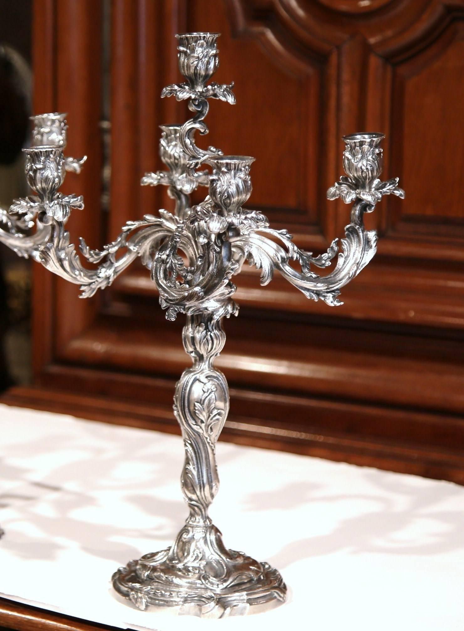 Decorate a table or console with this elegant antique bronze candleholders from Paris, France. Crafted, circa 1860, the silvered candelabra features five beautiful, scrolled arms with leaves and sits on a round ornate base. The delicate candlestick