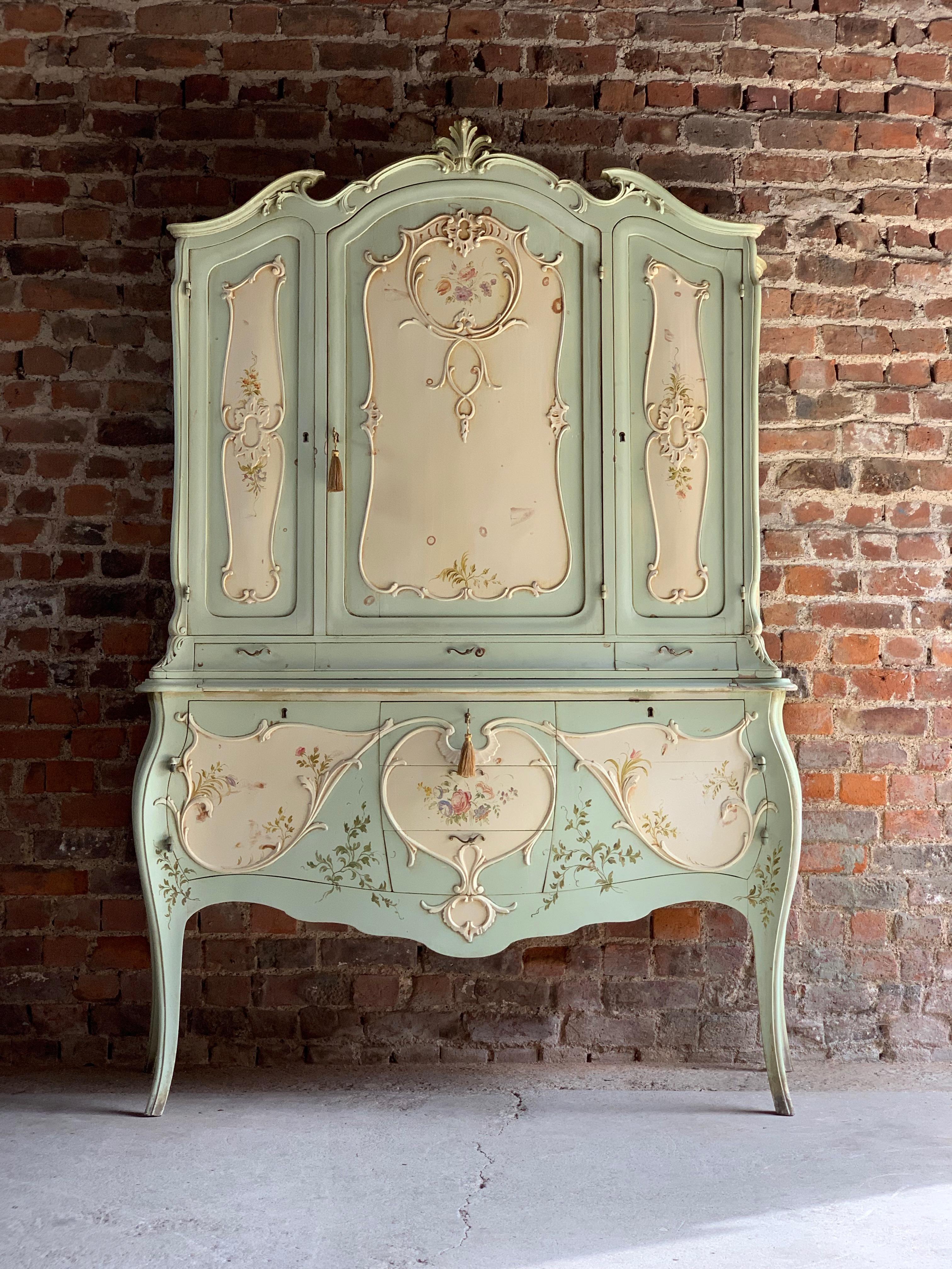A magnificent and decadent original lavishly carved and painted late 19th century French Louis XV style cabinet commode circa France 1890, the arched and scalloped moulded cornice embellished with foliage and flowers in carved relief, offering