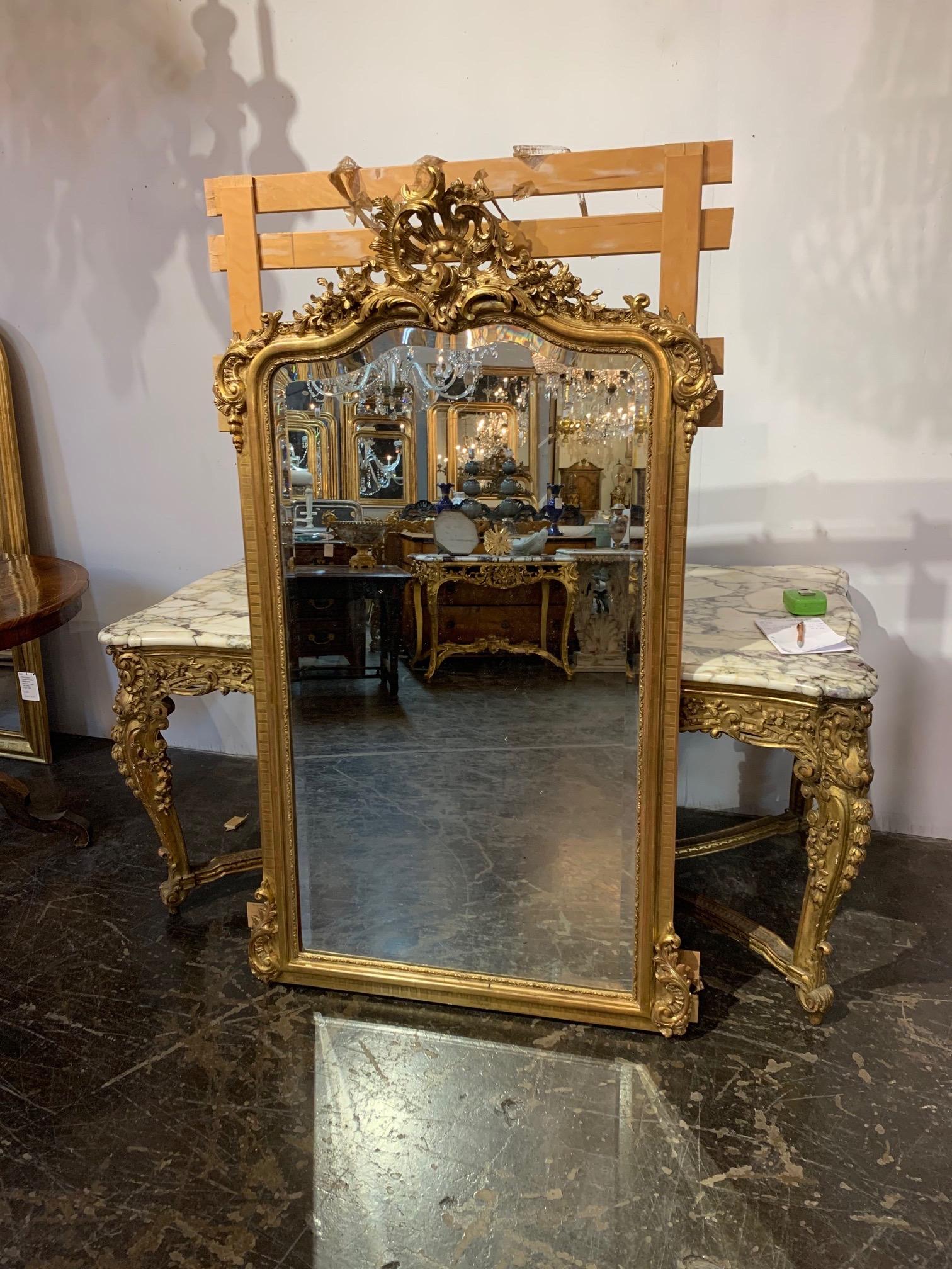 Lovely 19th century French Louis XV carved and giltwood mirror. Beautifully carved crest along with an exceptional gilt finish. A fabulous decorative mirror!