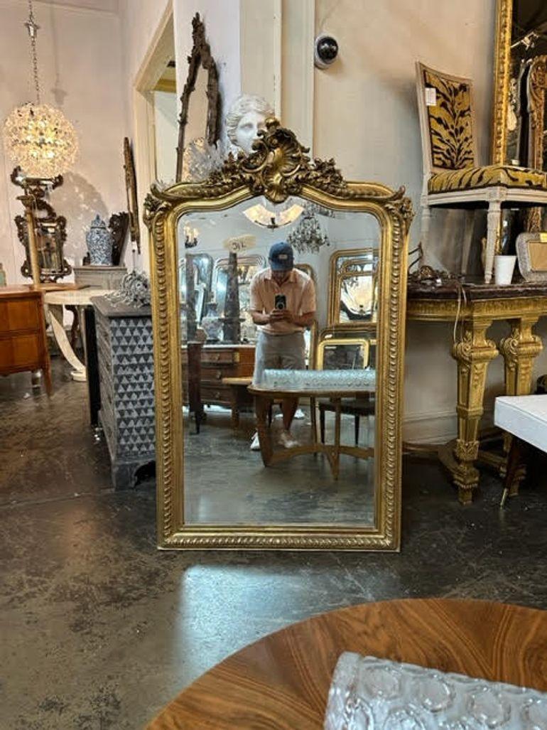 Gorgeous 19th century French Louis XV carved and giltwood mirror. Featuring an elaborate crest at the top. Very fine quality and sure to impress!!