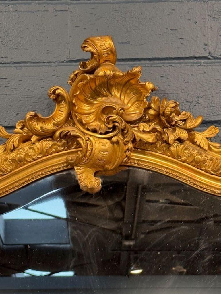 Elevate your space with the grandeur of the 19th Century French Louis XV Carved and Giltwood Mirror. Its intricate carvings and elegant giltwood detailing showcase a dedication to craftsmanship and design, making it a timeless addition to any room.