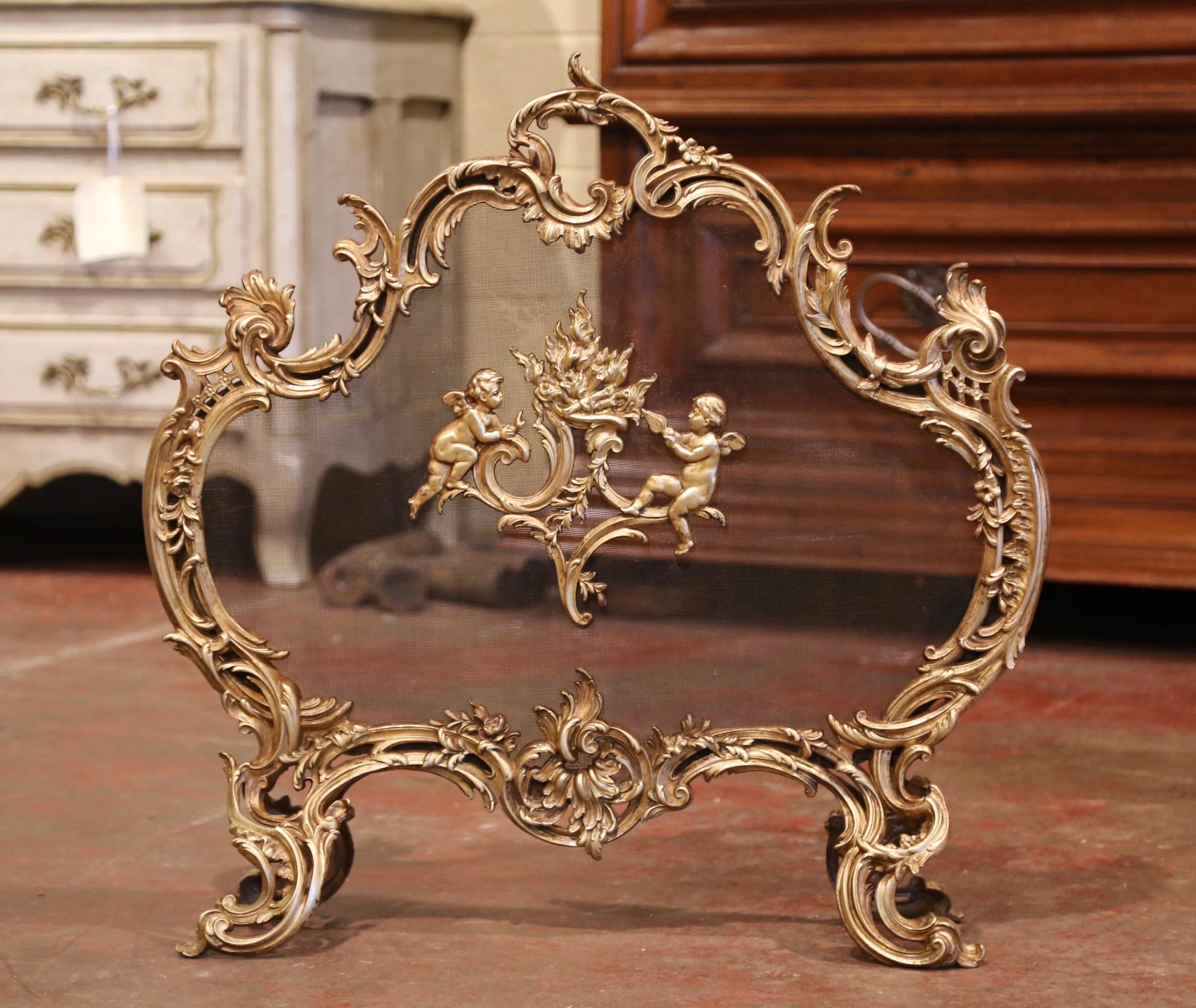 Decorate your fireplace with this elegant antique screen. Crafted in France circa 1870 and made of bronze, the shaped screen sits on four scrolled feet and features traditional Louis XV motifs including asymmetrical foliage swaths; it is further