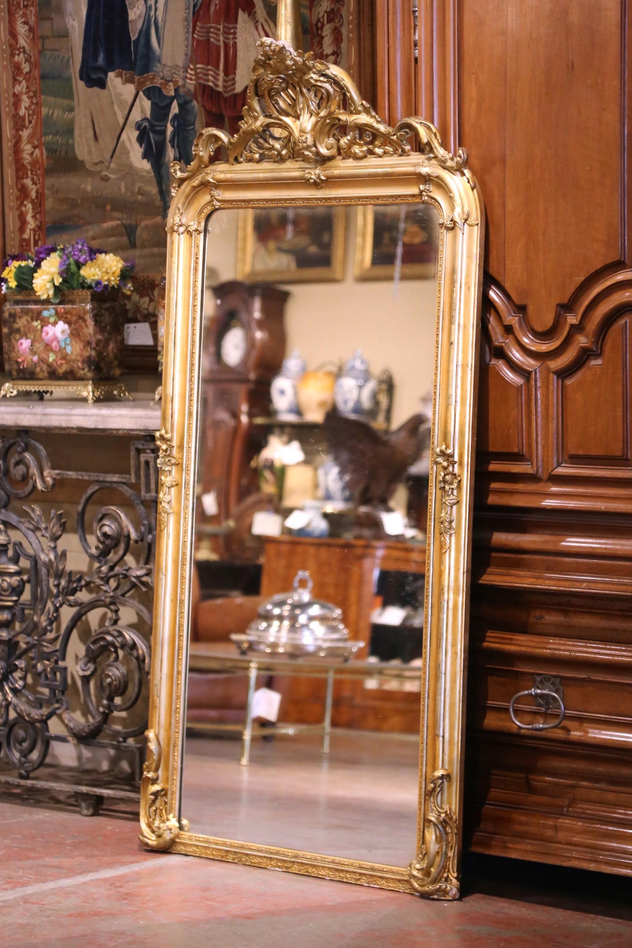  Décorez un grand couloir ou une cheminée avec cet impressionnant miroir antique de style Louis XV. Fabriqué en France vers 1860, ce miroir rectangulaire de près de 1,80 m de haut est enchâssé dans un cadre en bois doré sculpté à la main et décoré