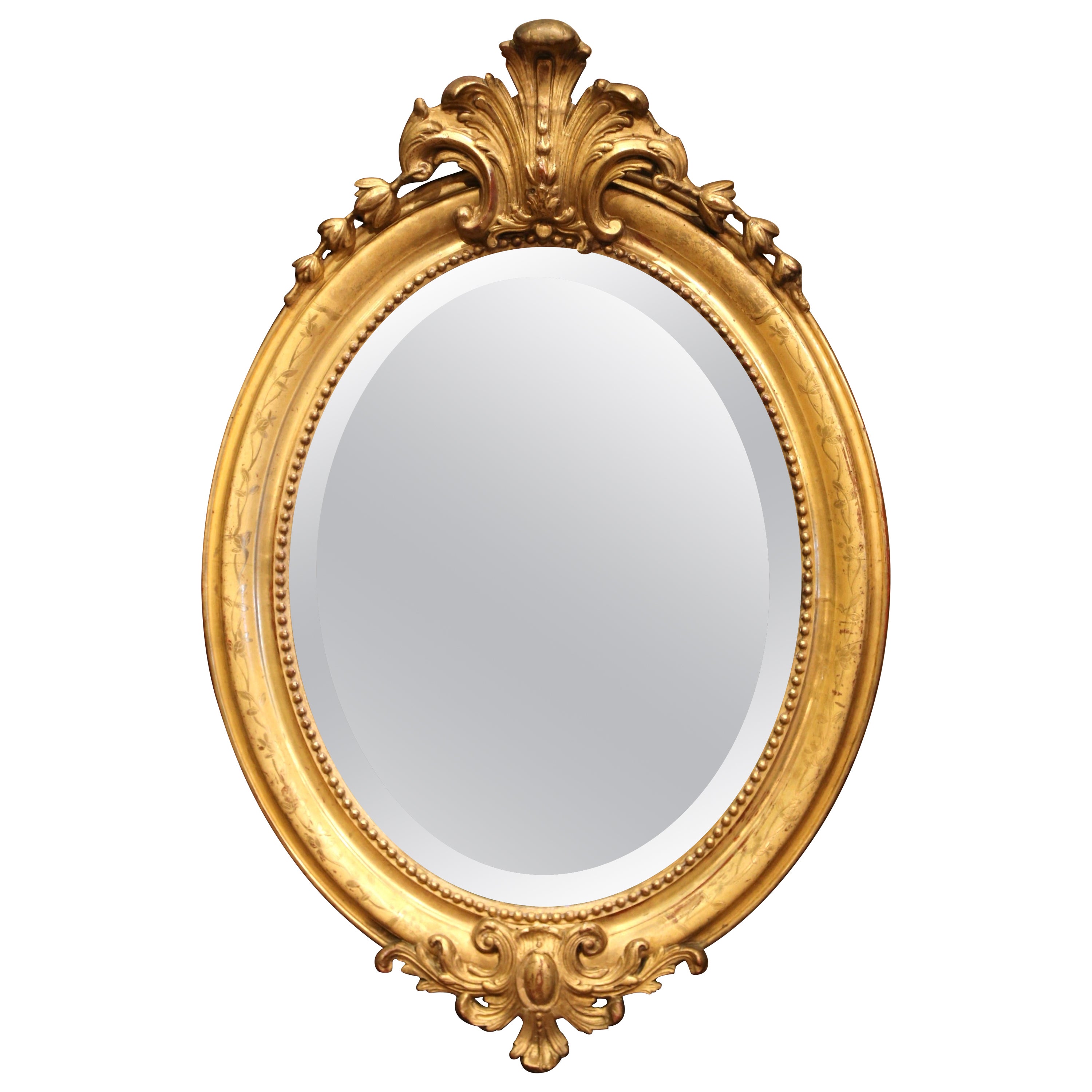 Miroir ovale Louis XV du 19ème siècle en bois doré sculpté avec cartouche en coquillage en vente