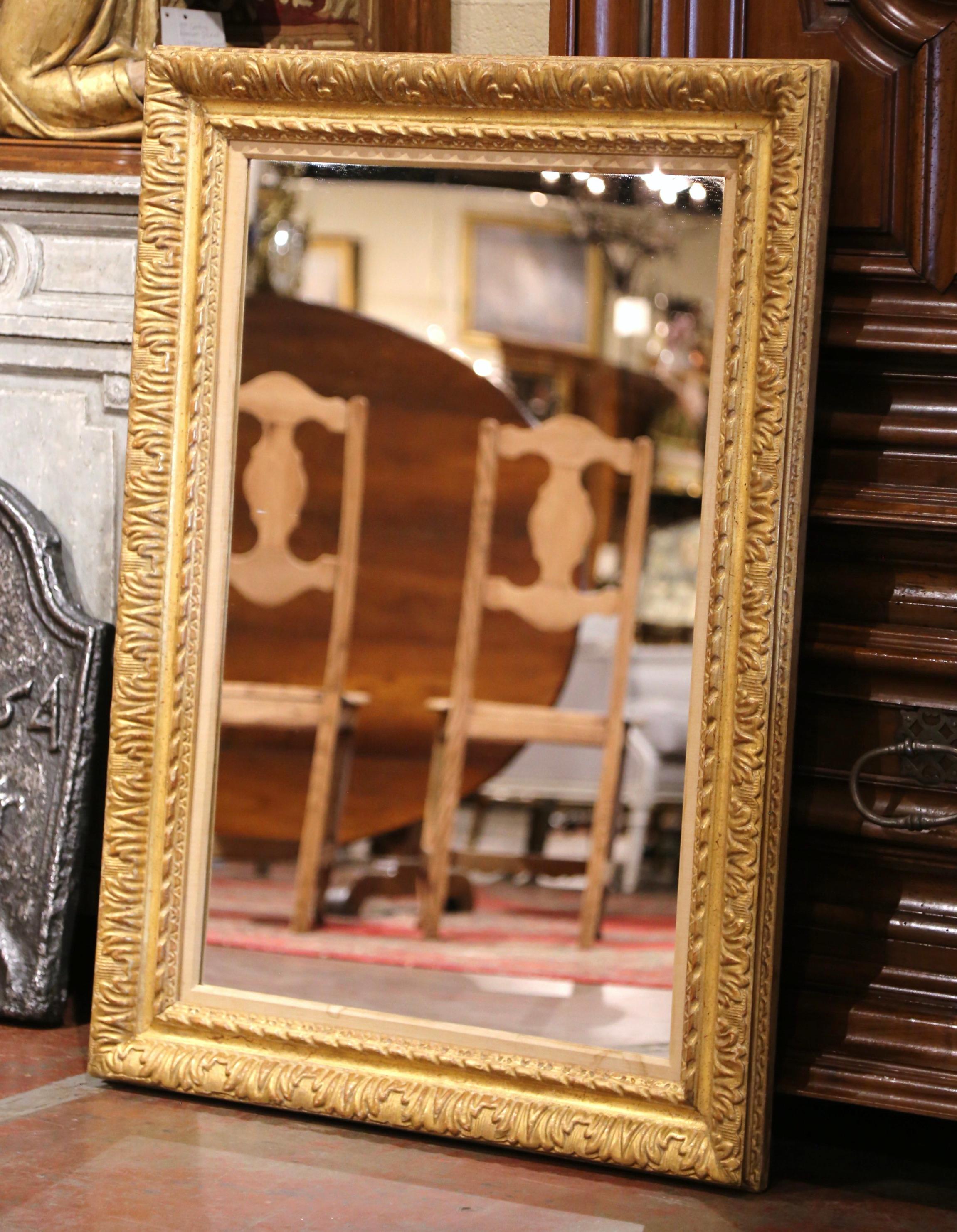 This elegant mirror was created in France, circa 1890. Rectangular in shape, the large mirror can be hang vertically or horizontally; the frame features exquisite hand carved floral decor, and is embellished with a cartouche shell motif in each