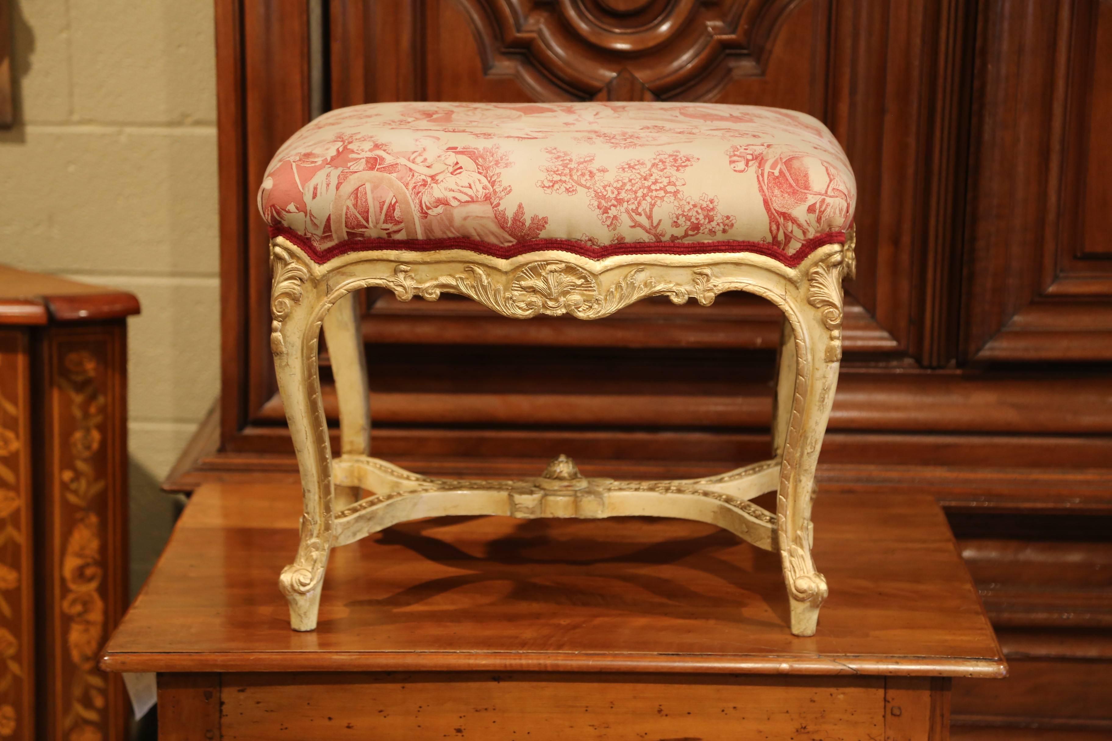 Colorful and elegant, this antique stool will add a charming, French character to your home. Crafted in France, circa 1870, the hand carved stool features intricate carvings including shell and acanthus leaf decor on the scalloped apron, over four