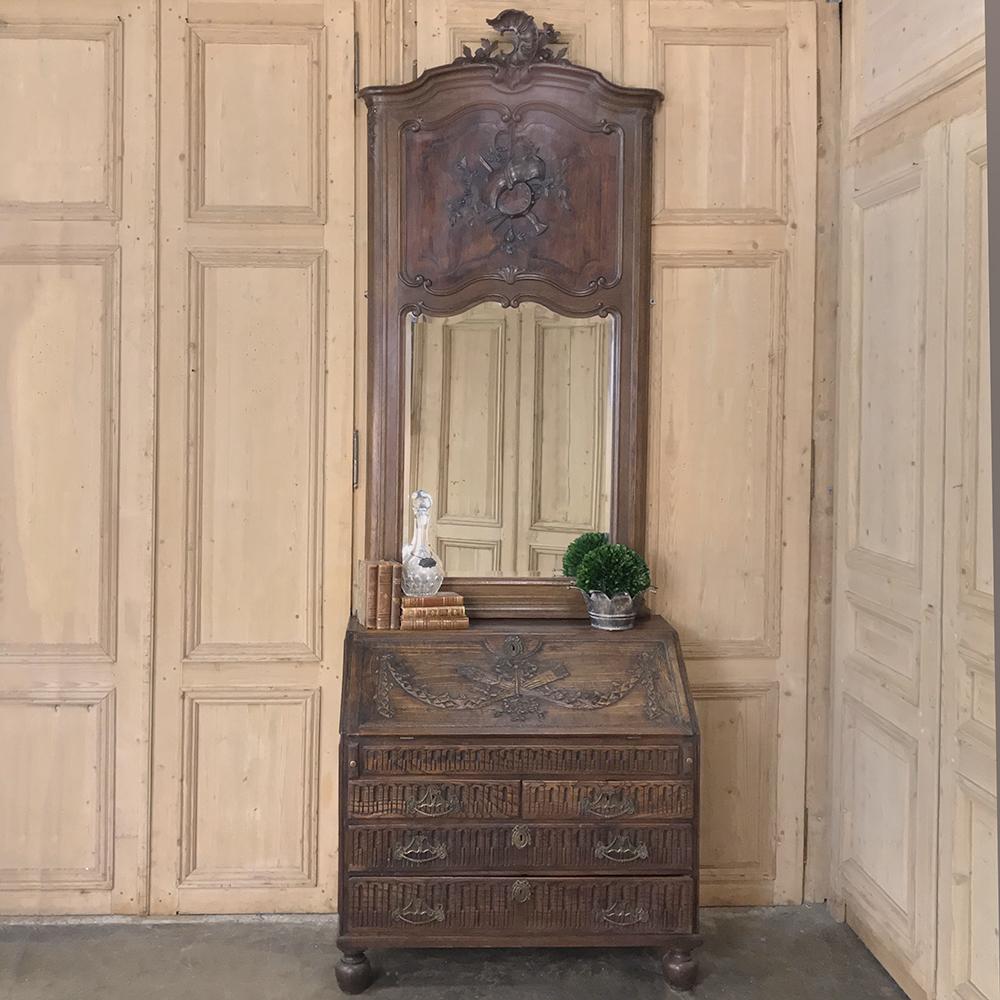 19th century French Louis XV carved Trumeau with Beveled Mirror boasts a beautiful arched crown centered with a Rococo shell and foliate carving, leading the eye down to the upper panel with full relief carvings of musical instruments and sheet