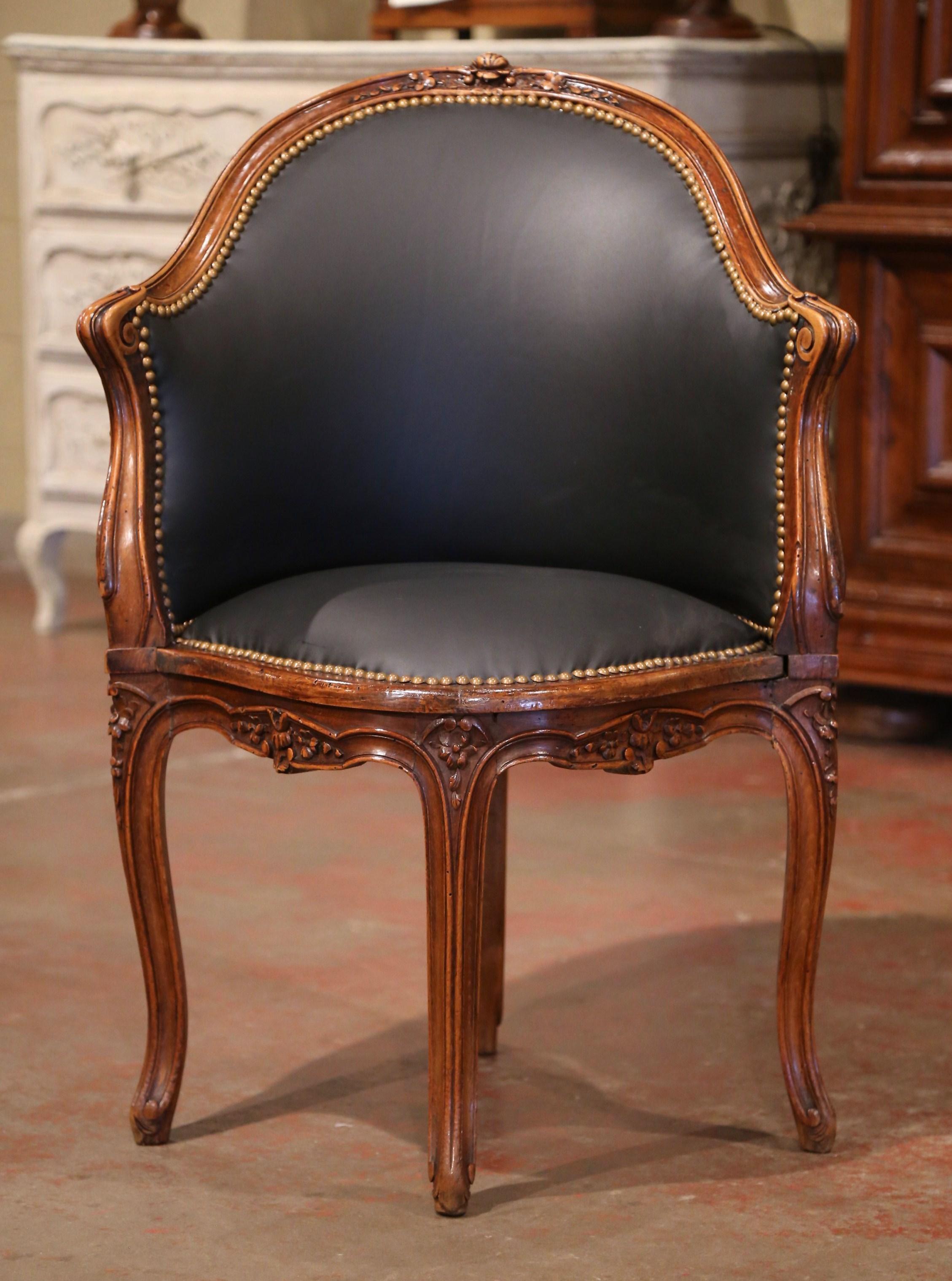 Decorate a study or office with this beautiful antique desk chair. Crafted in Provence, France, circa 1850 and shaped as a corner seating, the armchair features a curved and arched back decorated with carved floral motif at the pediment. The Louis
