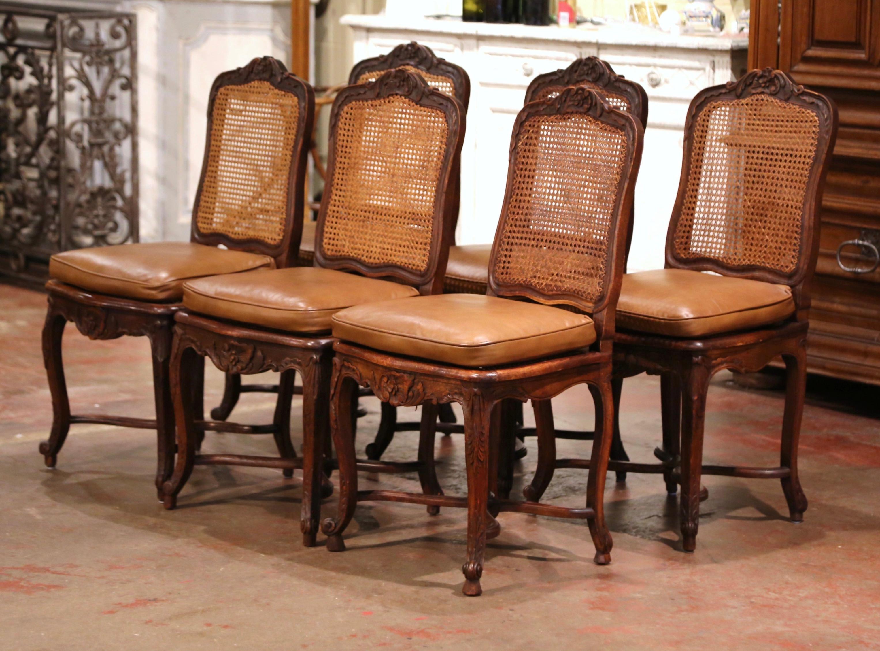Decorate a dining table with this elegant suite of antique side chairs. Crafted in France circa 1880, each chair stands on cabriole legs ending with escargot feet over an X bottom stretcher decorated with a floral medallion. Scalloped apron