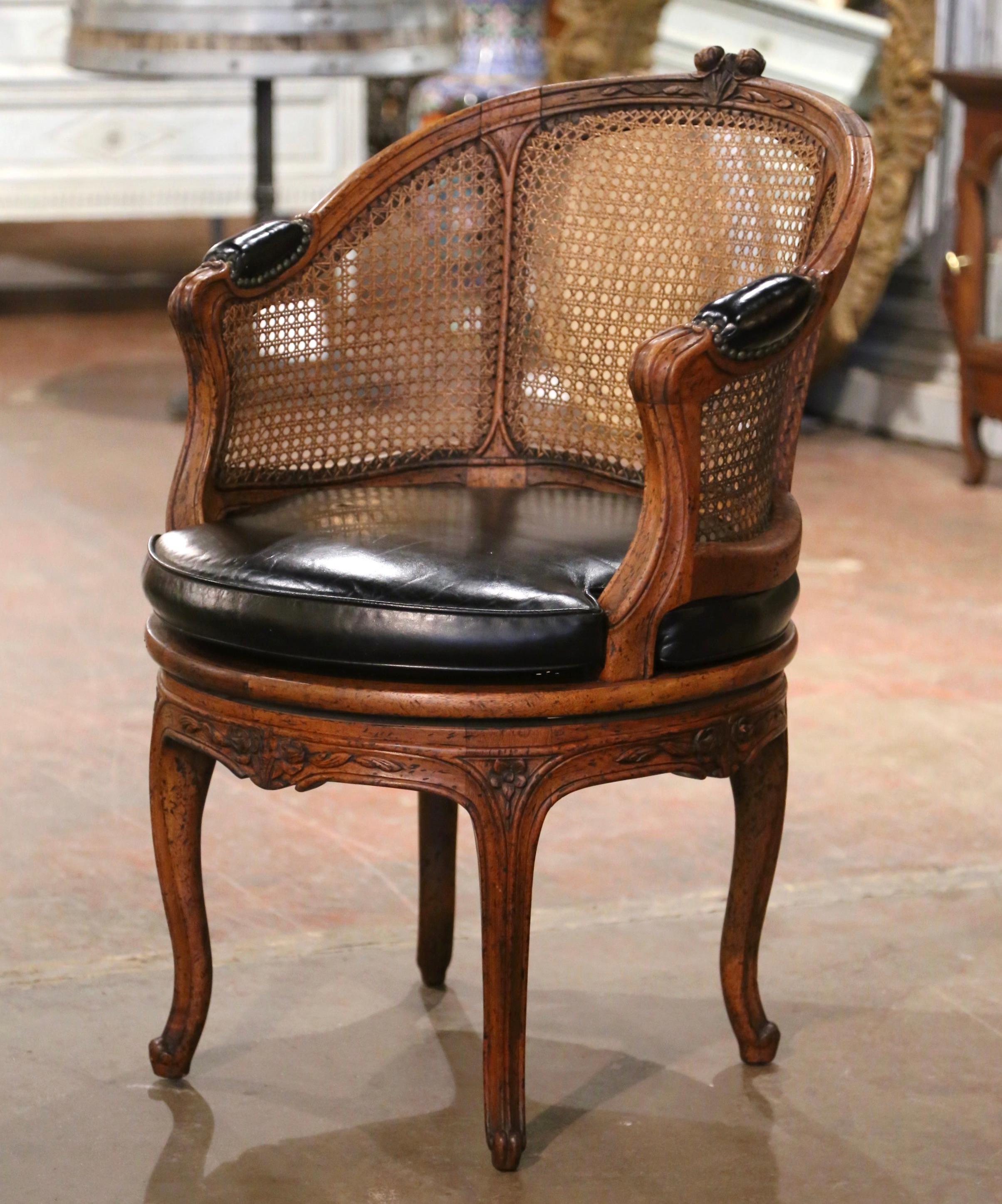 Decorate a study or office with this elegant antique fruitwood desk armchair. Crafted in Northern France, circa 1880, the desk chair stands on cabriole legs decorated with floral rosette motifs at the shoulders, ending with scroll feet, over a bombe