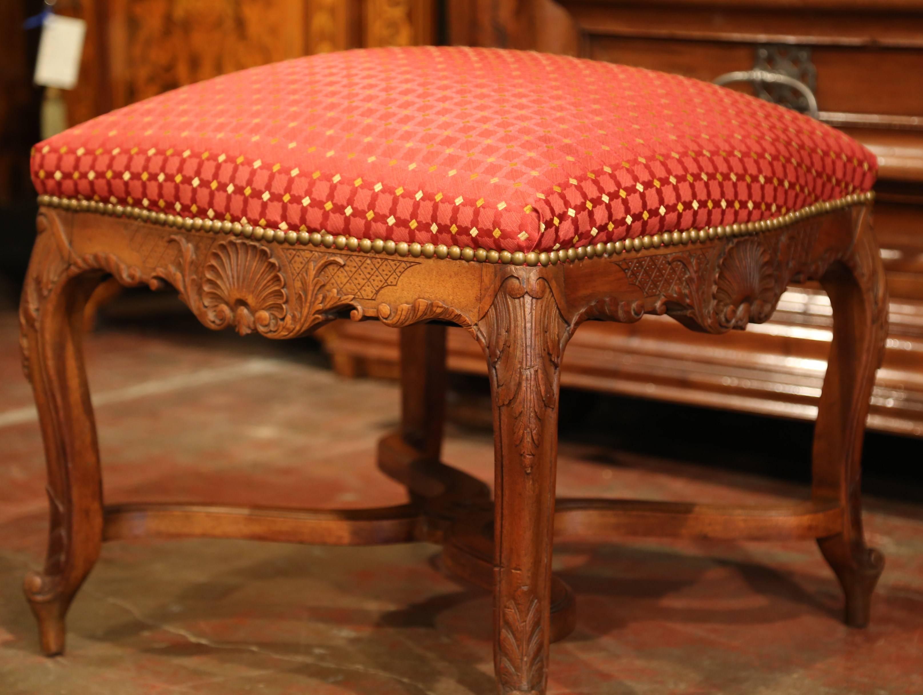 Colorful and elegant, this antique stool will add a charming French character to your home. Crafted in southern France, circa 1880, the hand-carved stool features intricate work including shell carvings on the scalloped apron, cabriole legs with