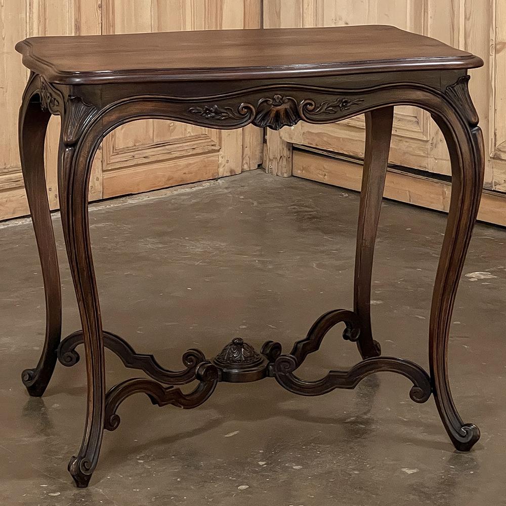 19th Century French Louis XV fruitwood end table is a classic example of the genre, with violin-shaped top displaying the fine grain of the wood, with a beveled edge that leads the eye to the exquisitely scrolled apron that has been hand-carved with